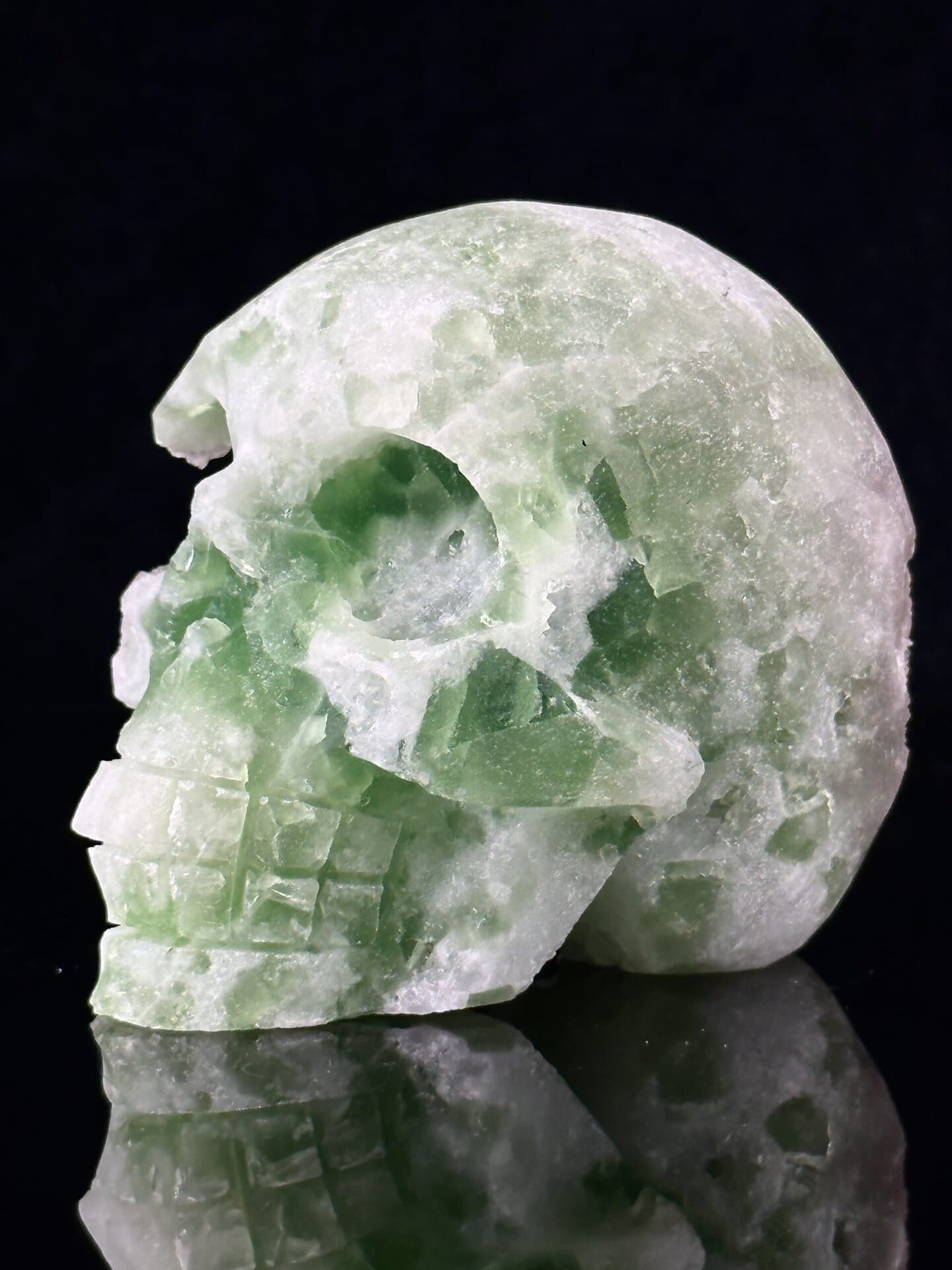 Hand-carved green fluorite skull specimen with natural translucence, popular among modern mineral collectors
