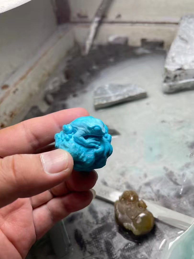 Artisan sketching design for a crystal carving.