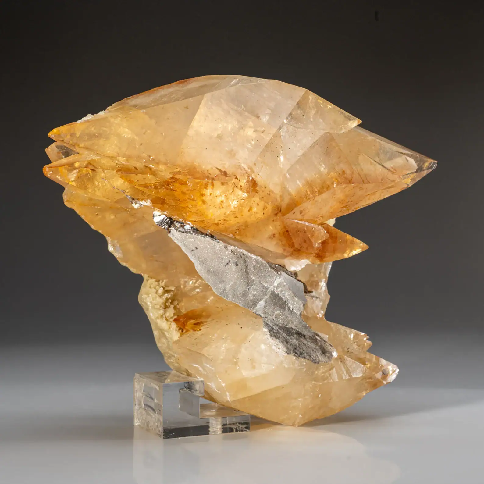 Golden calcite crystal perched on purple fluorite from Elmwood, Tennessee.