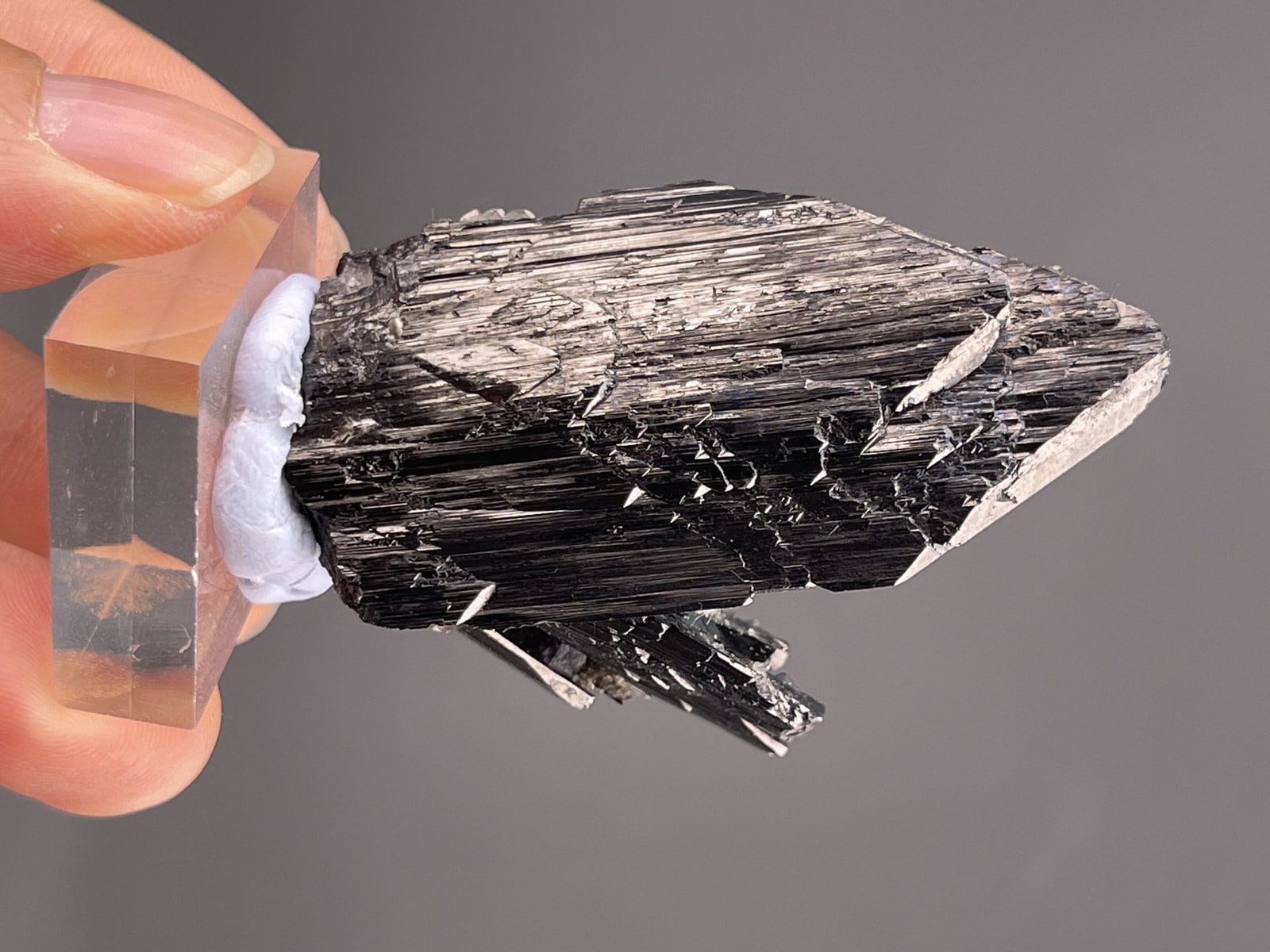 Close-up of cassiterite crystals showing metallic luster on barite