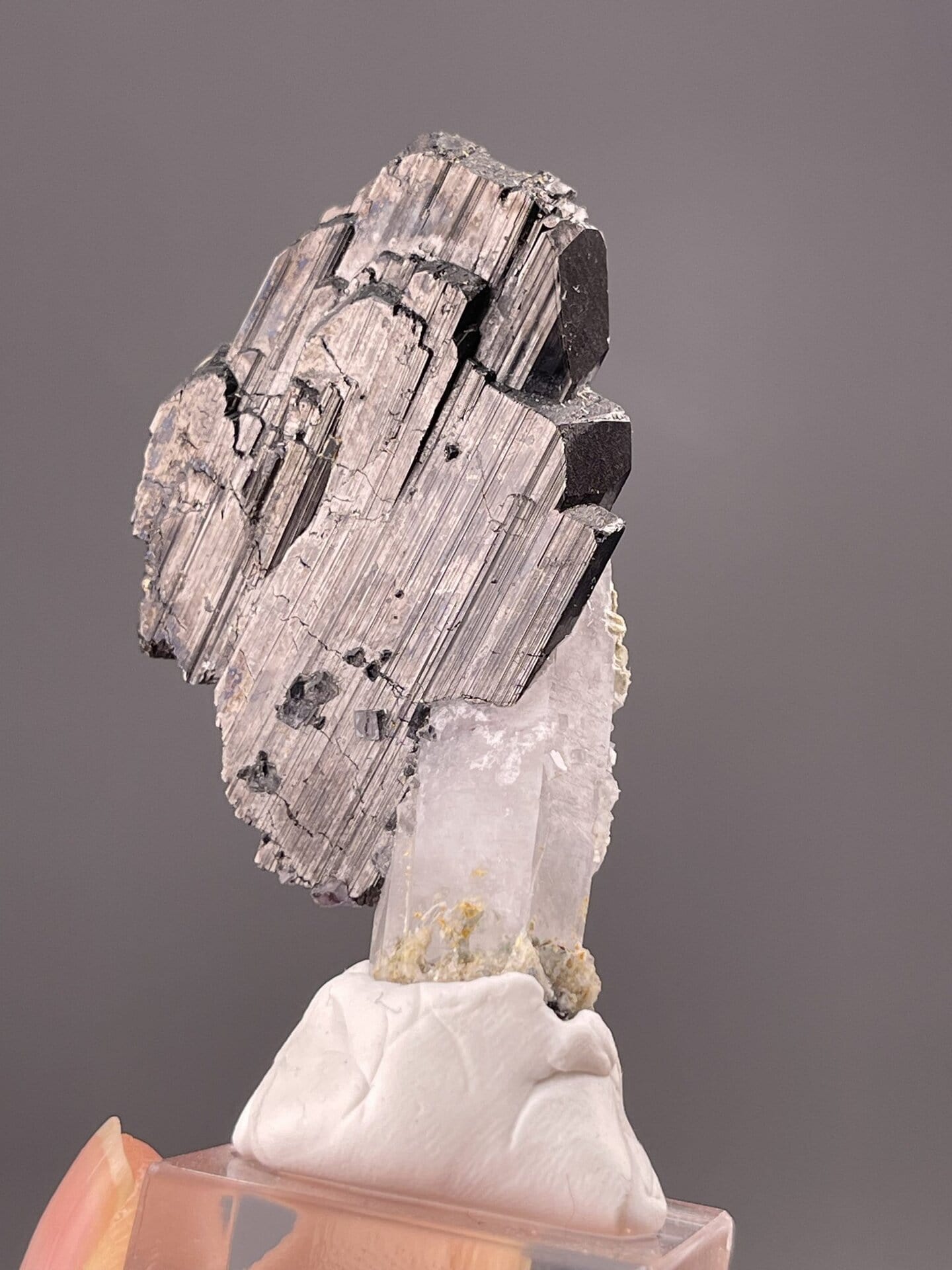 Close-up of cassiterite showing longitudinal striations and metallic luster