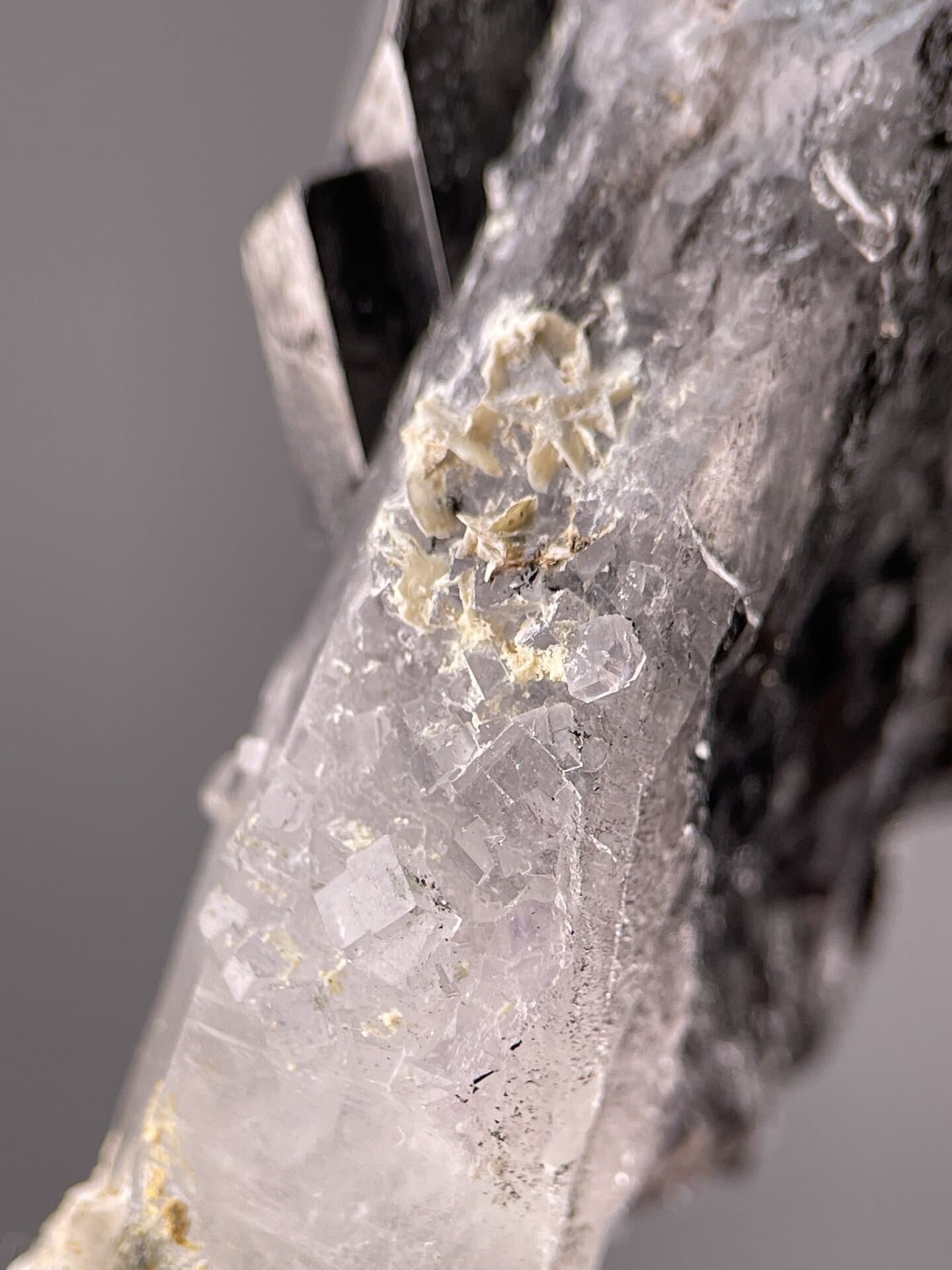 Detail of cassiterite surface showing metallic sheen and striations