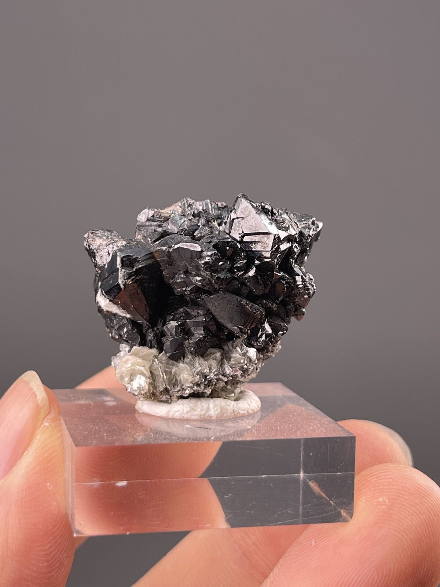 Close-up of cassiterite faces showing metallic luster and dark colour