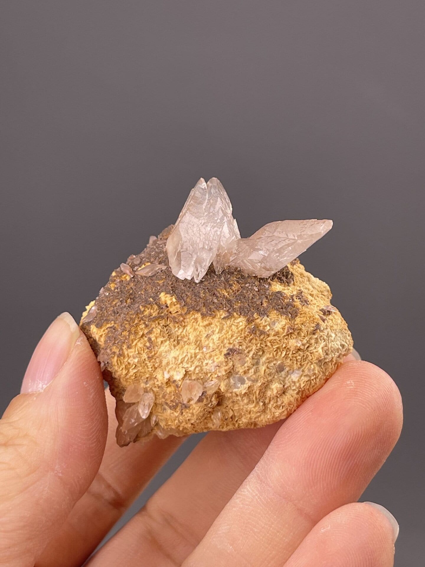 Close-up of calcite crystal faces showing brown colour and luster