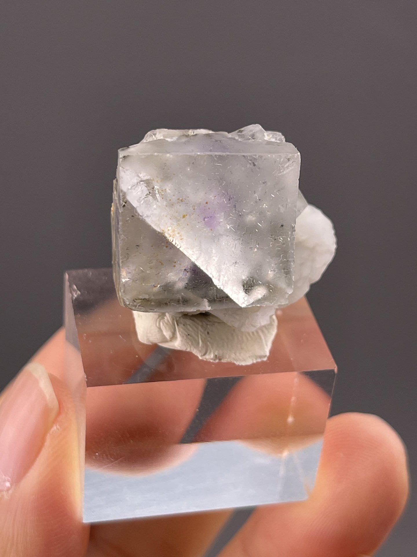 Side view of colorless fluorite cube showing sharp edges