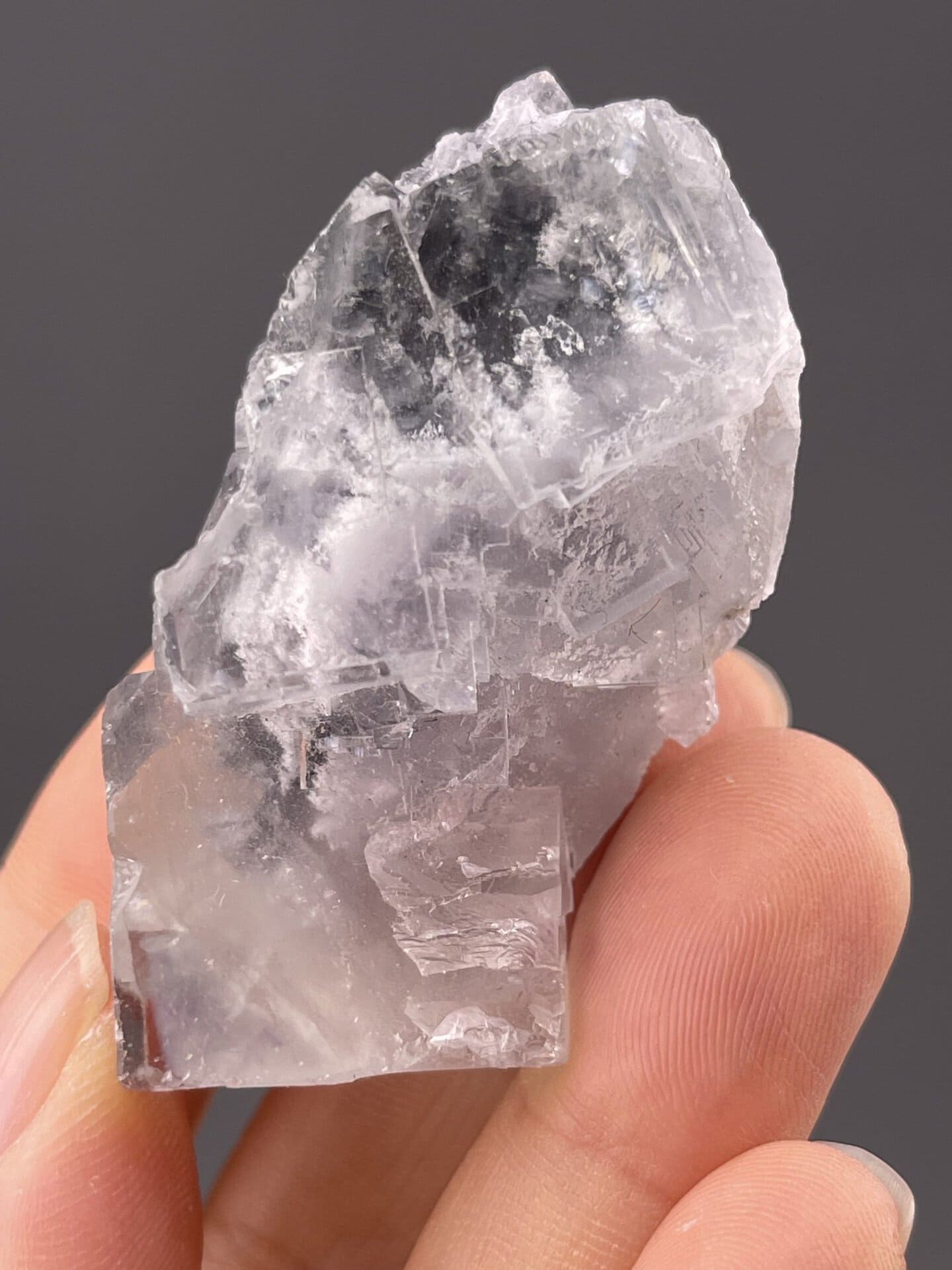 Transparent fluorite twin showing iridescent play of colour, 1.6 g