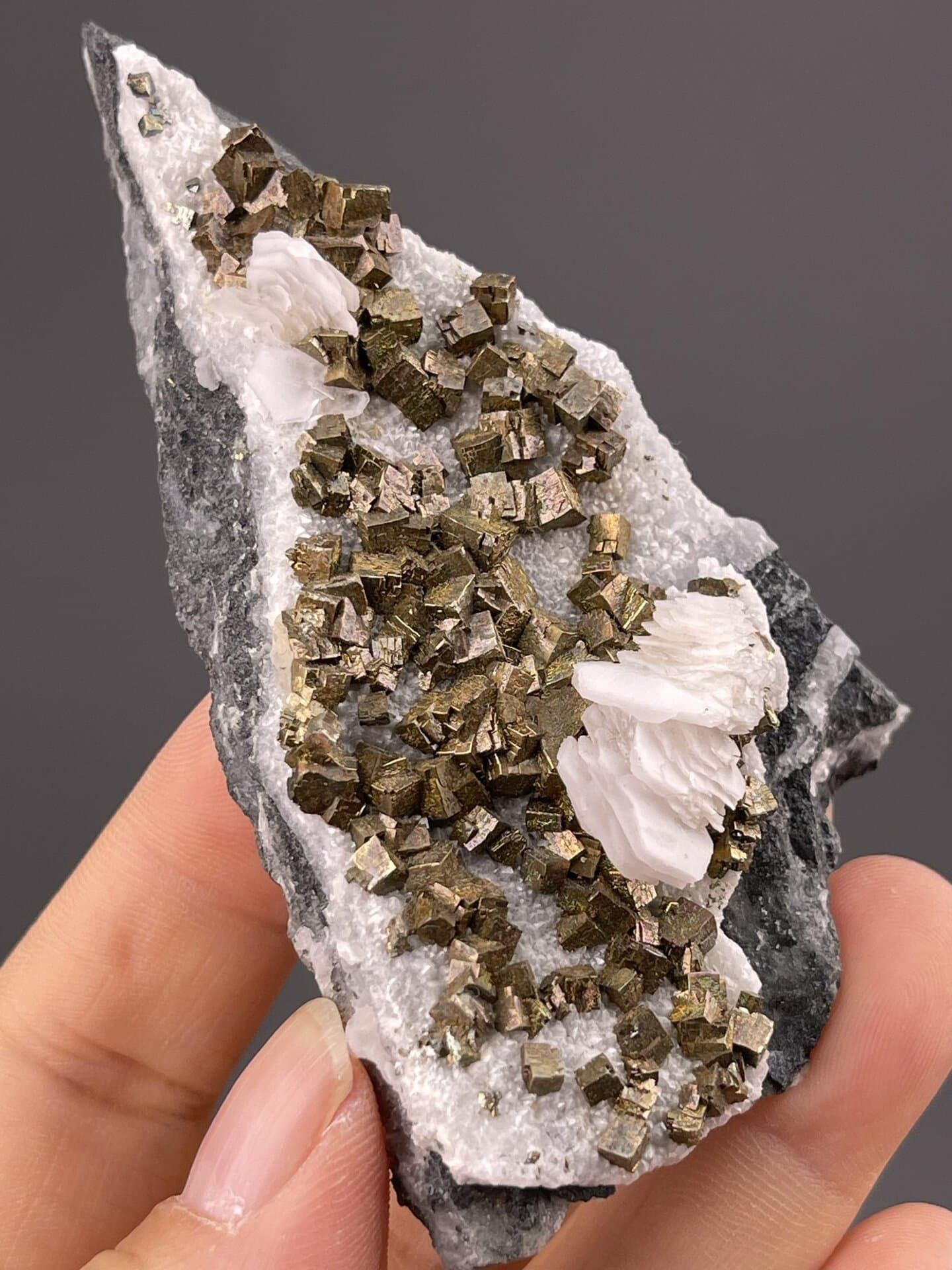 Side view of pyrite-calcite specimen showing mineral association