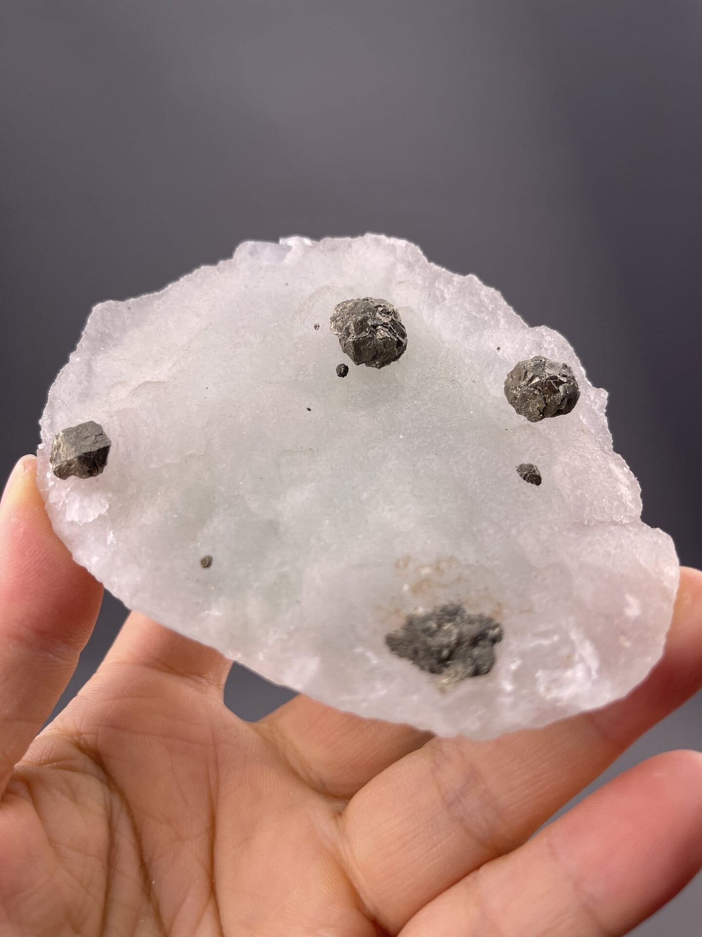 Close-up of green fluorite crystals on black magnetite matrix