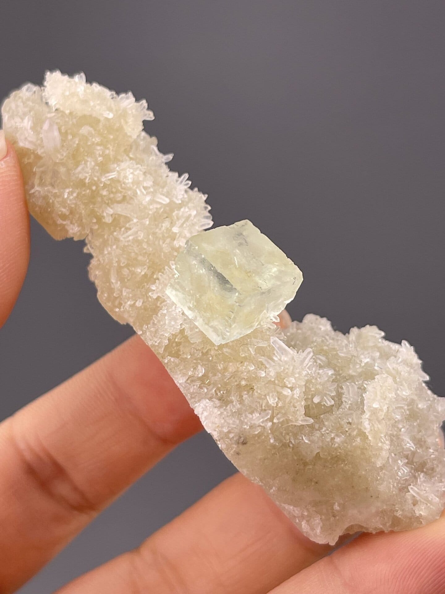 Detail of fluorite surface showing pastel green tone and luster