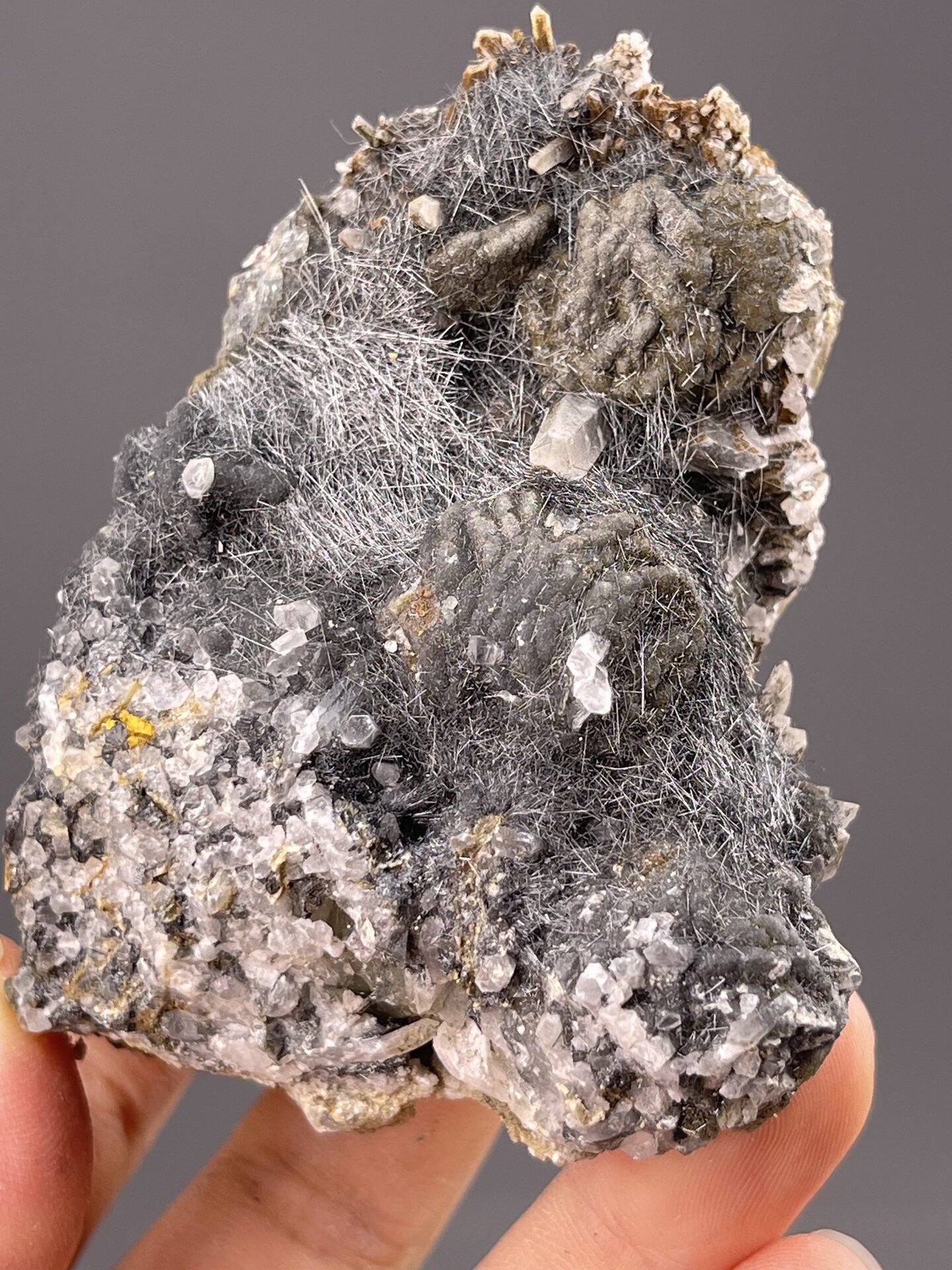 Close-up of bismuthinite crystal needles showing metallic sheen