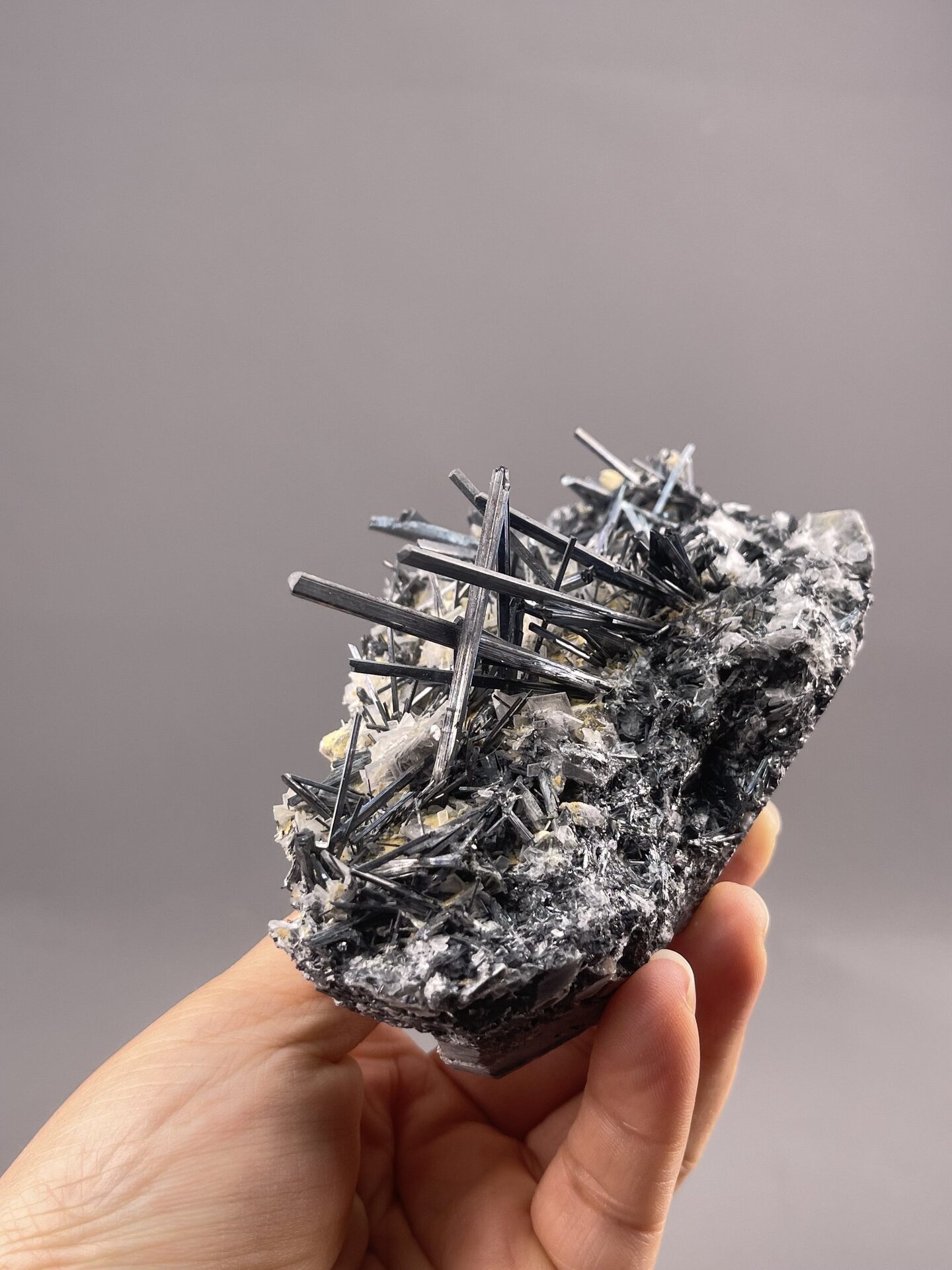Stibnite Acicular Cluster from Lengshuijiang Mine, Hunan – angled view showing matrix