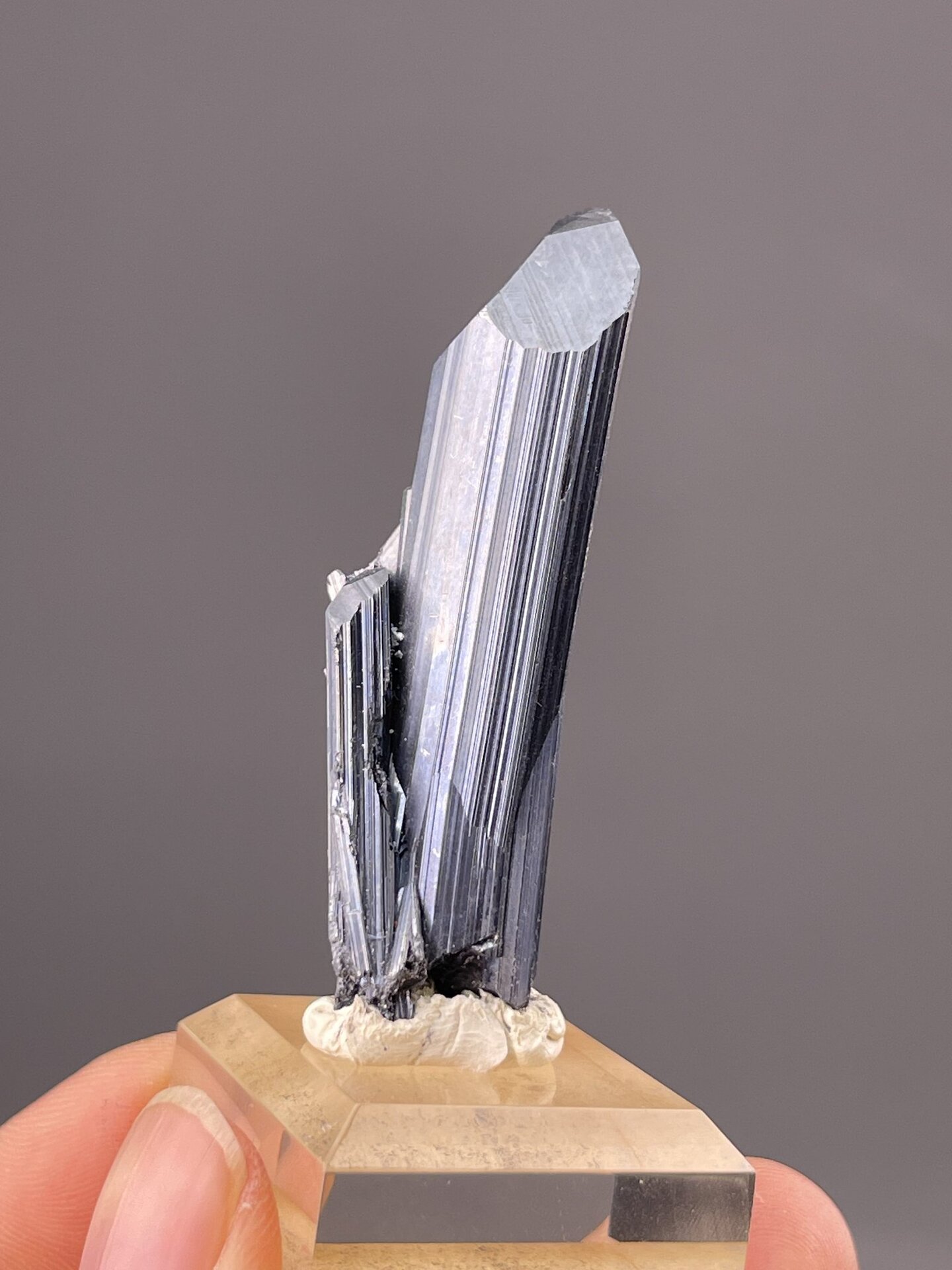 Close-up of stibnite crystal faces showing metallic gray colour