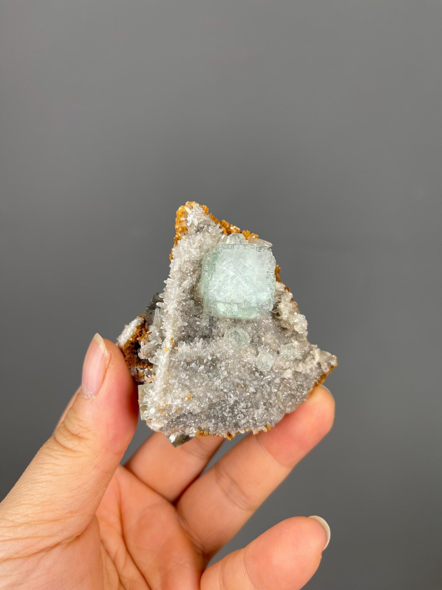 Front view of green fluorite cube with white calcite from China