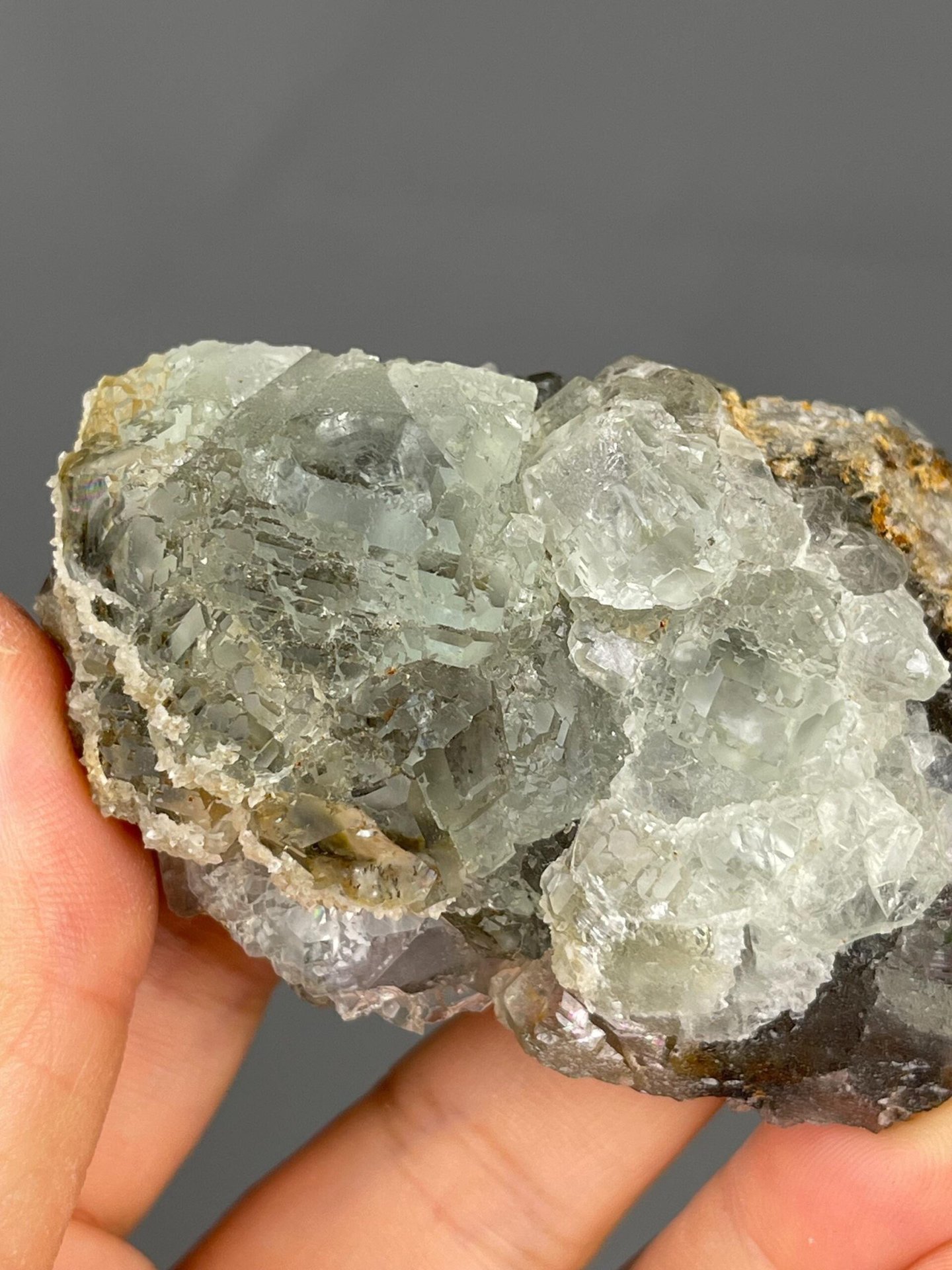 Side view of fluorite cube on rock matrix