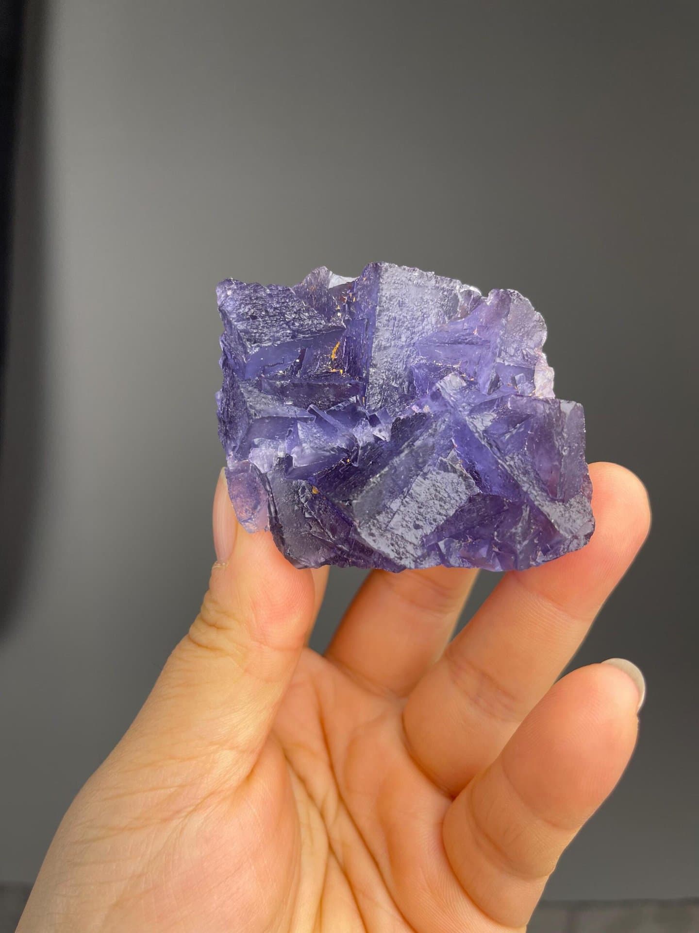 Close-up of floating purple fluorite formations on matrix