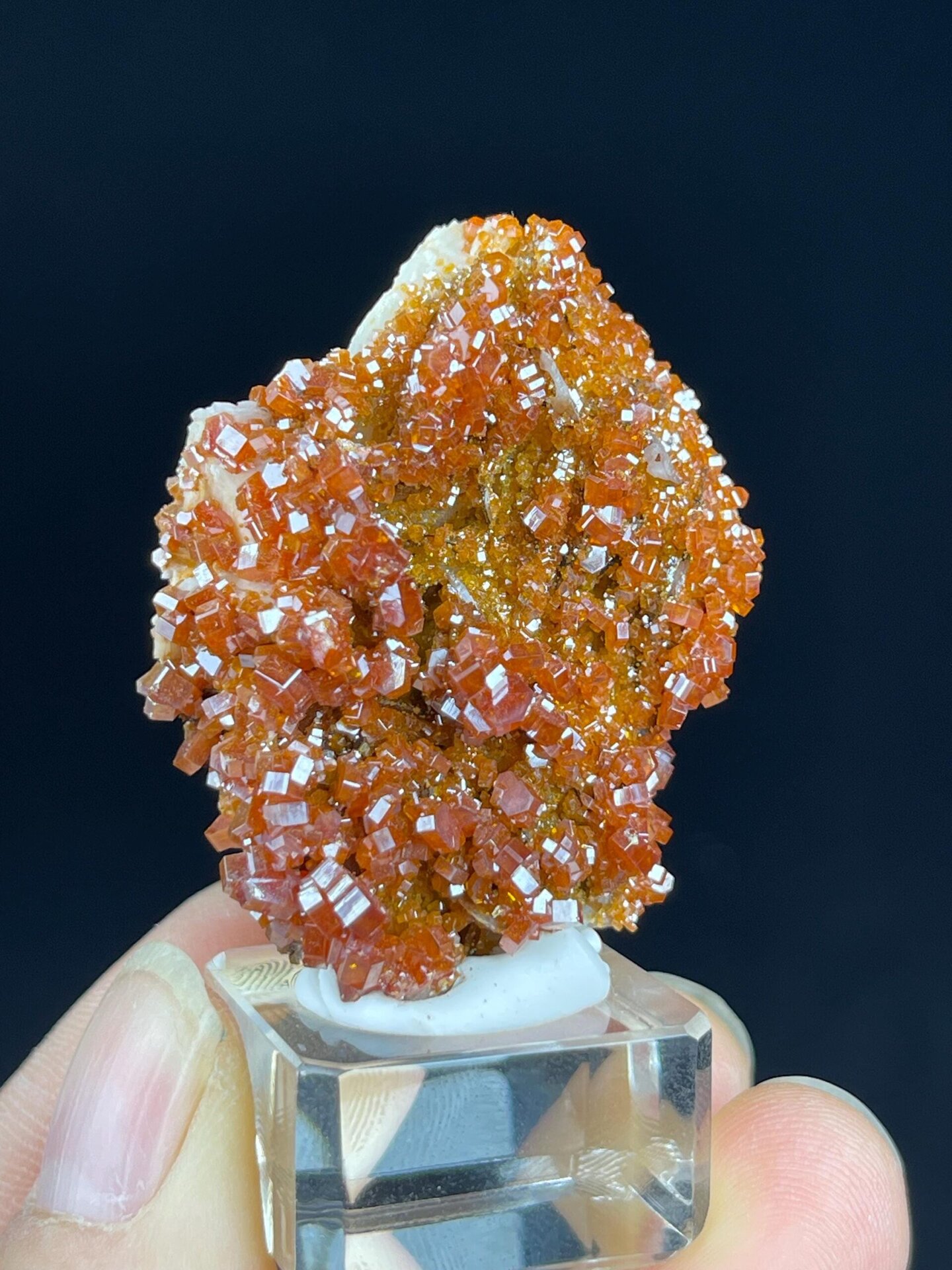 Close-up of glossy red-orange wulfenite crystal faces