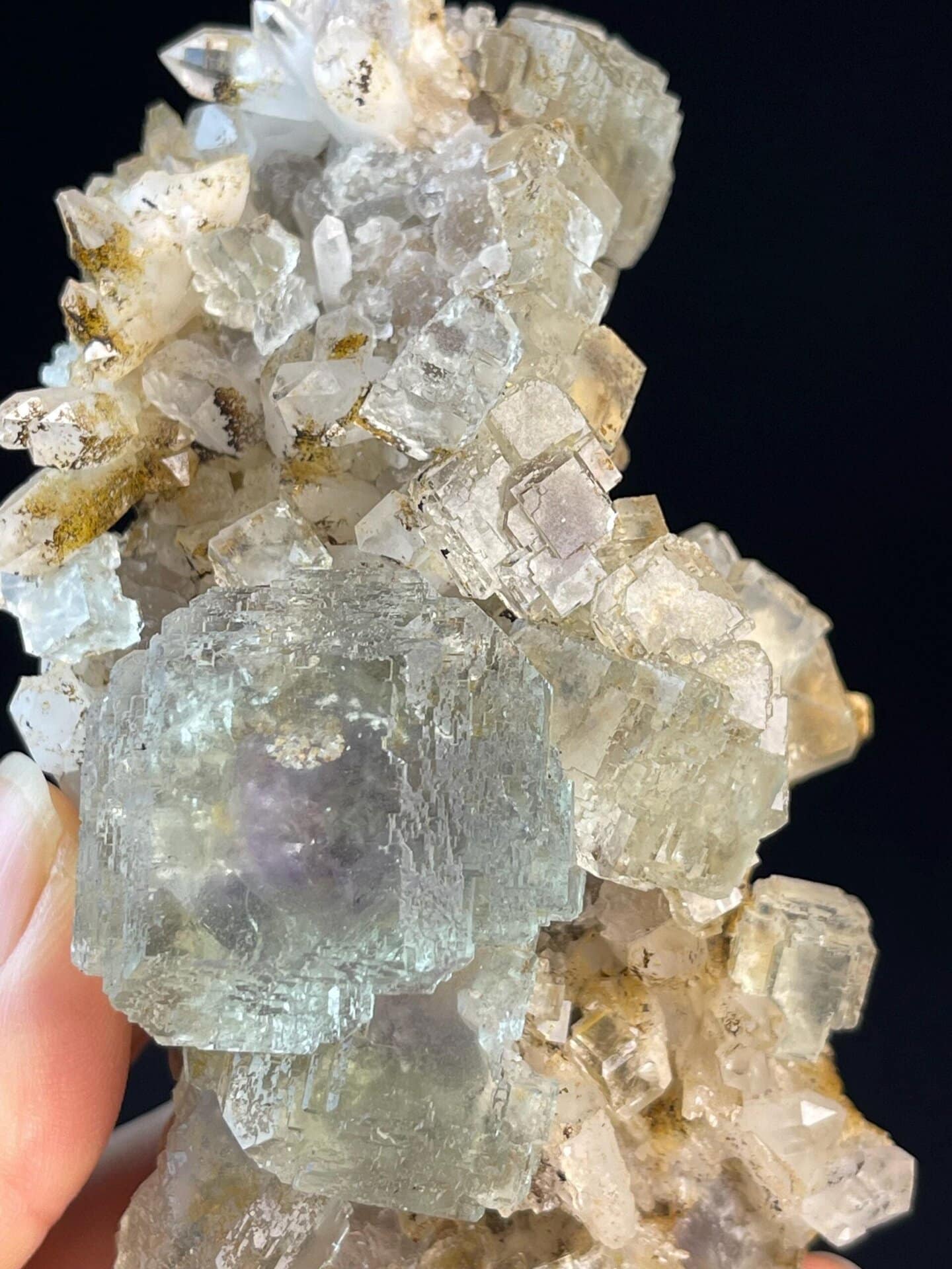 Large transparent window on purple stepped fluorite
