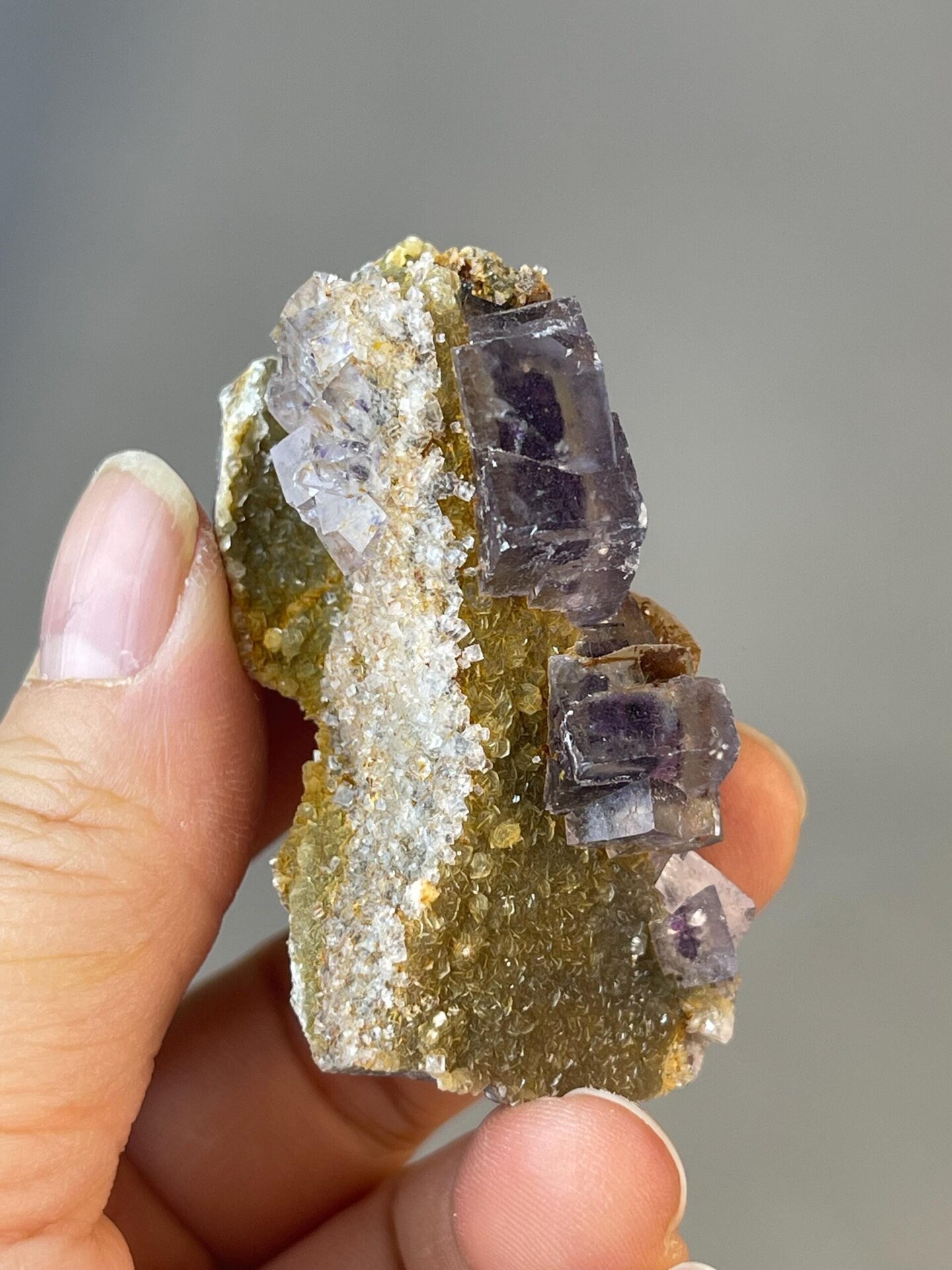 Close-up of purple inclusions inside clear fluorite