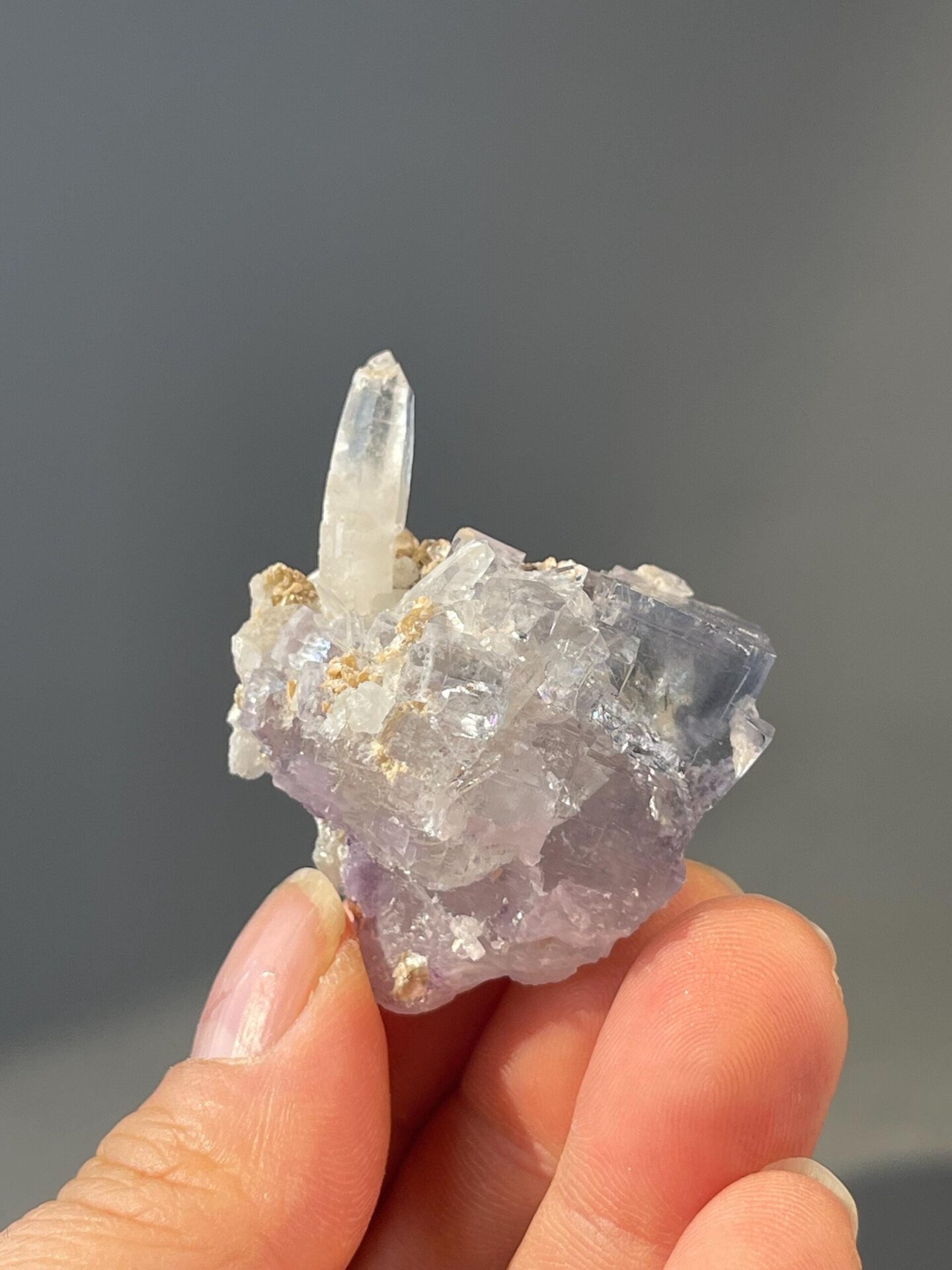 Quartz crystal column alongside blue fluorite