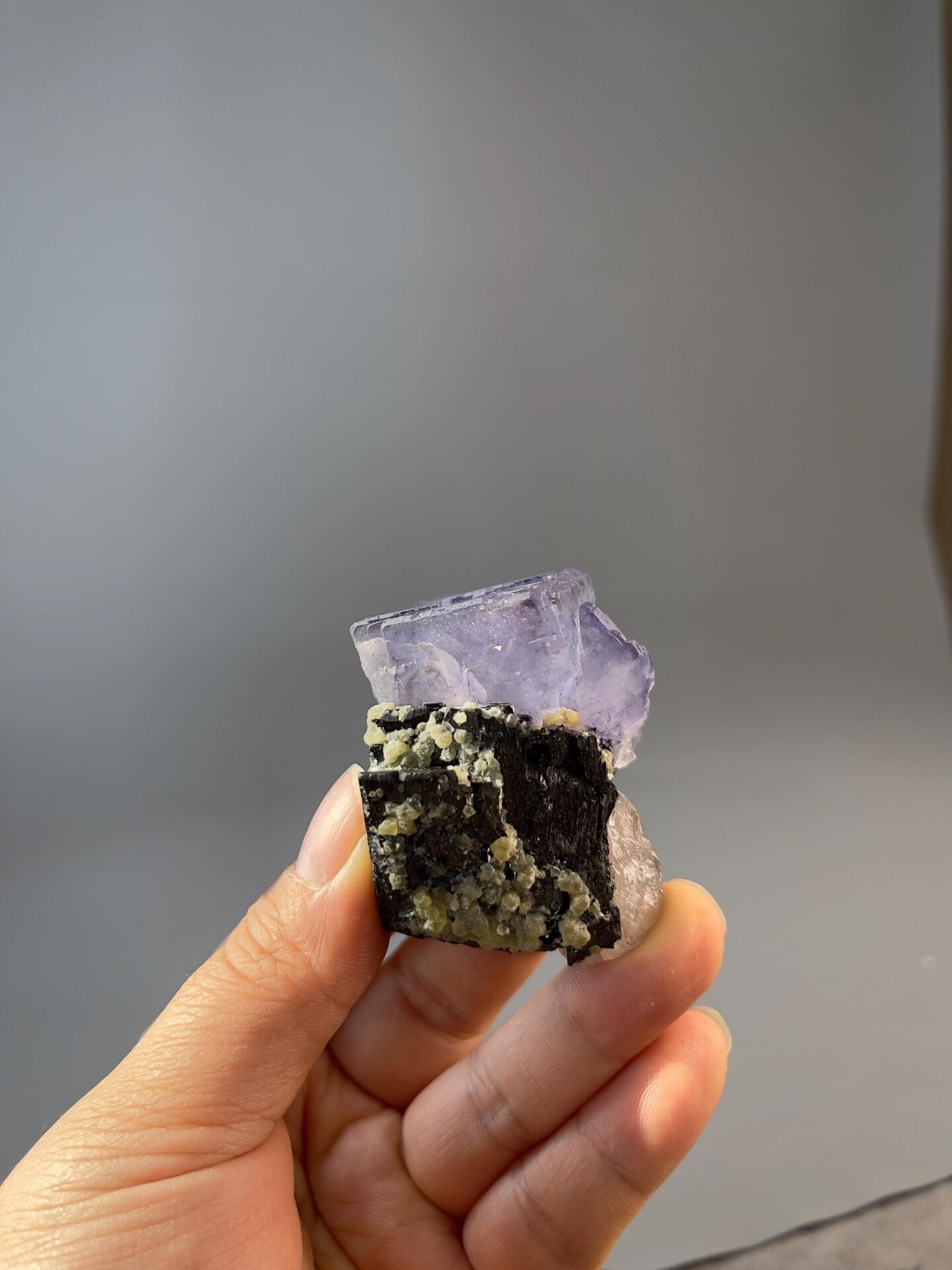 Yaogangxian fluorite twin with black matrix under light