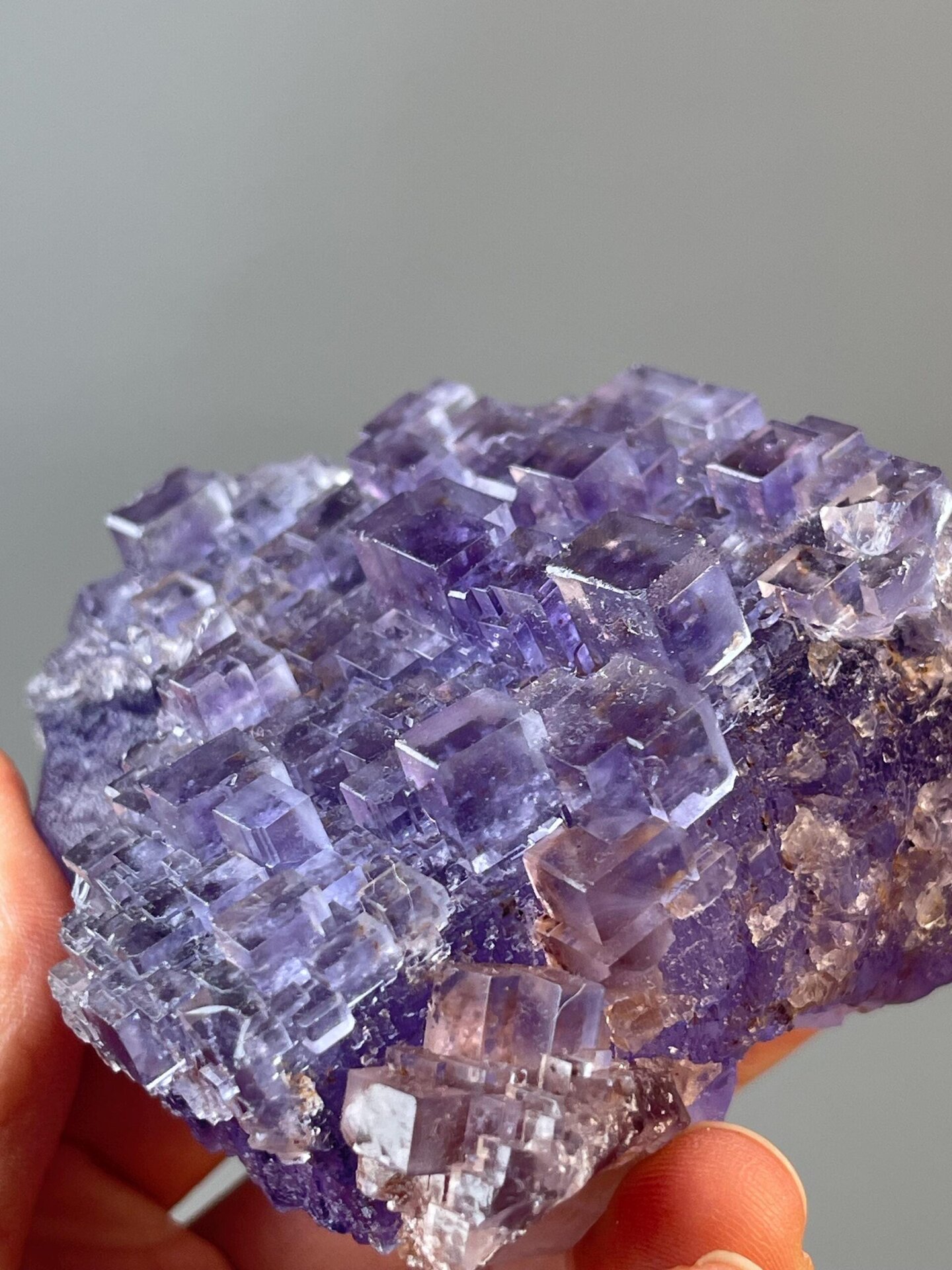 Multiple stepped cube faces on fluorite cluster