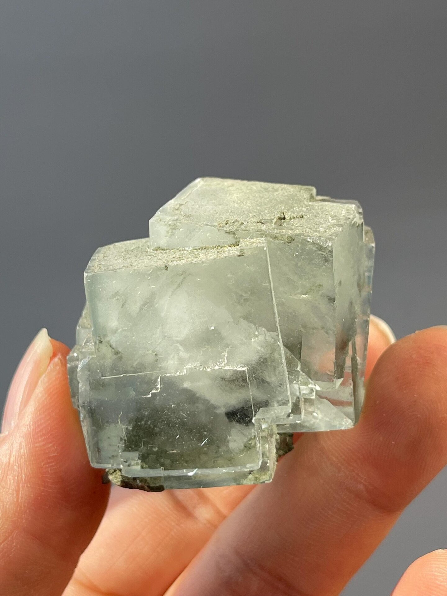 Cotton-like inclusions visible inside twin fluorite
