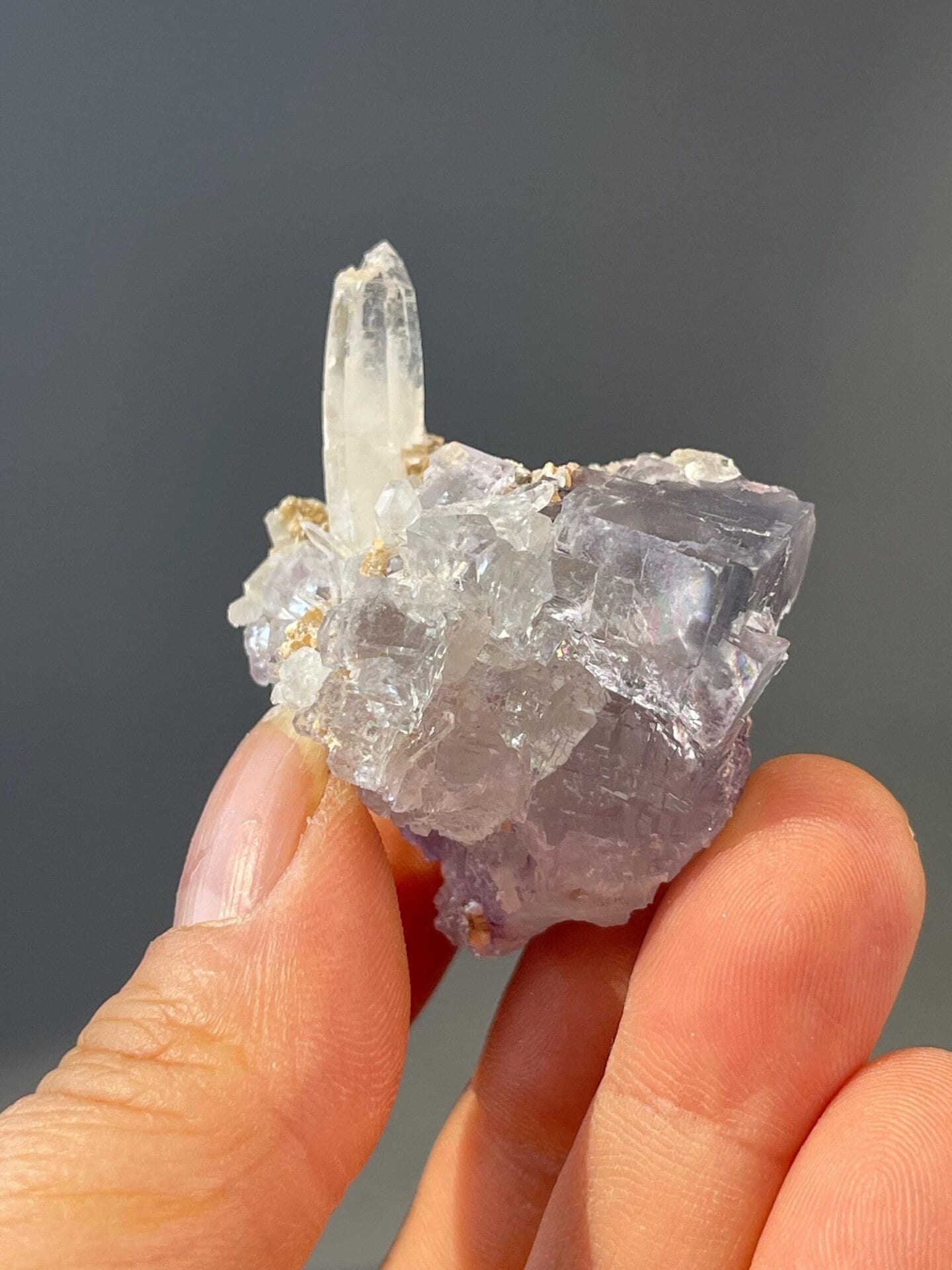 Close-up of columnar quartz crystal on blue fluorite