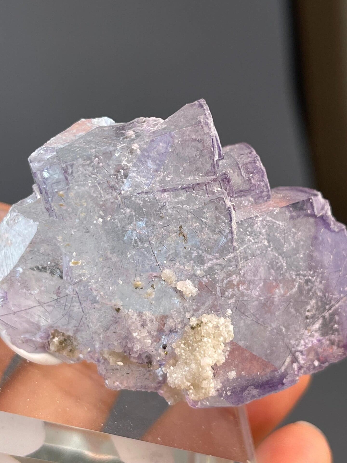 Stepped fluorite cube with silver needle mineral inclusions