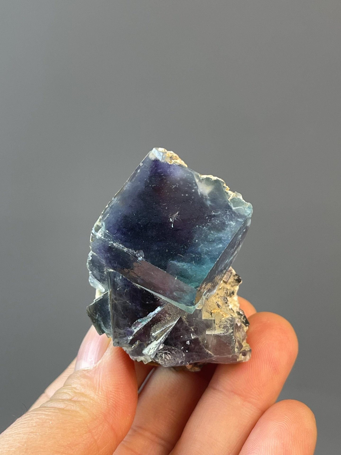 Blue fluorite cube with deep purple and blue phantom inclusions