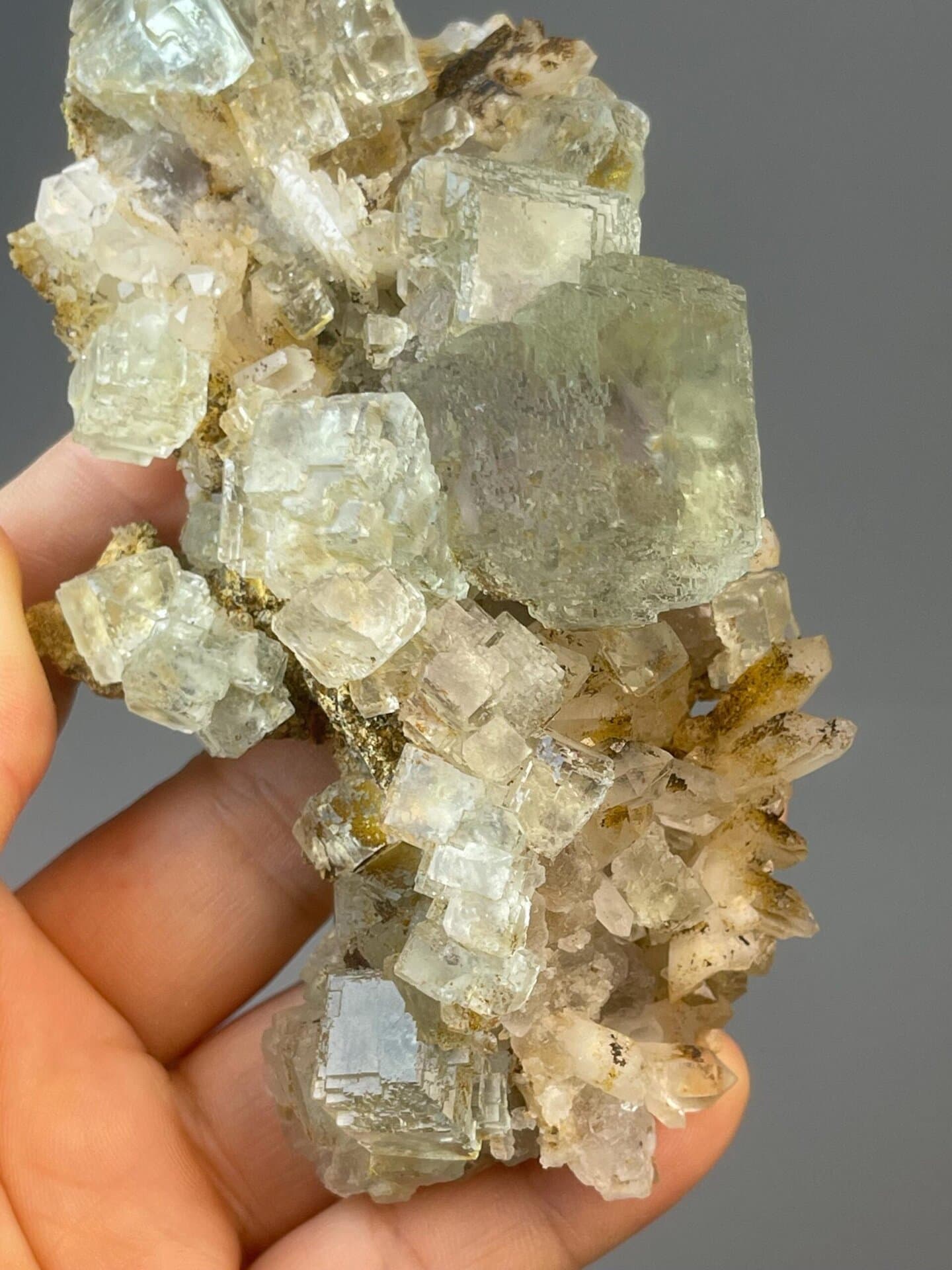 Green CaF₂ fluorite cluster with bold color on matrix