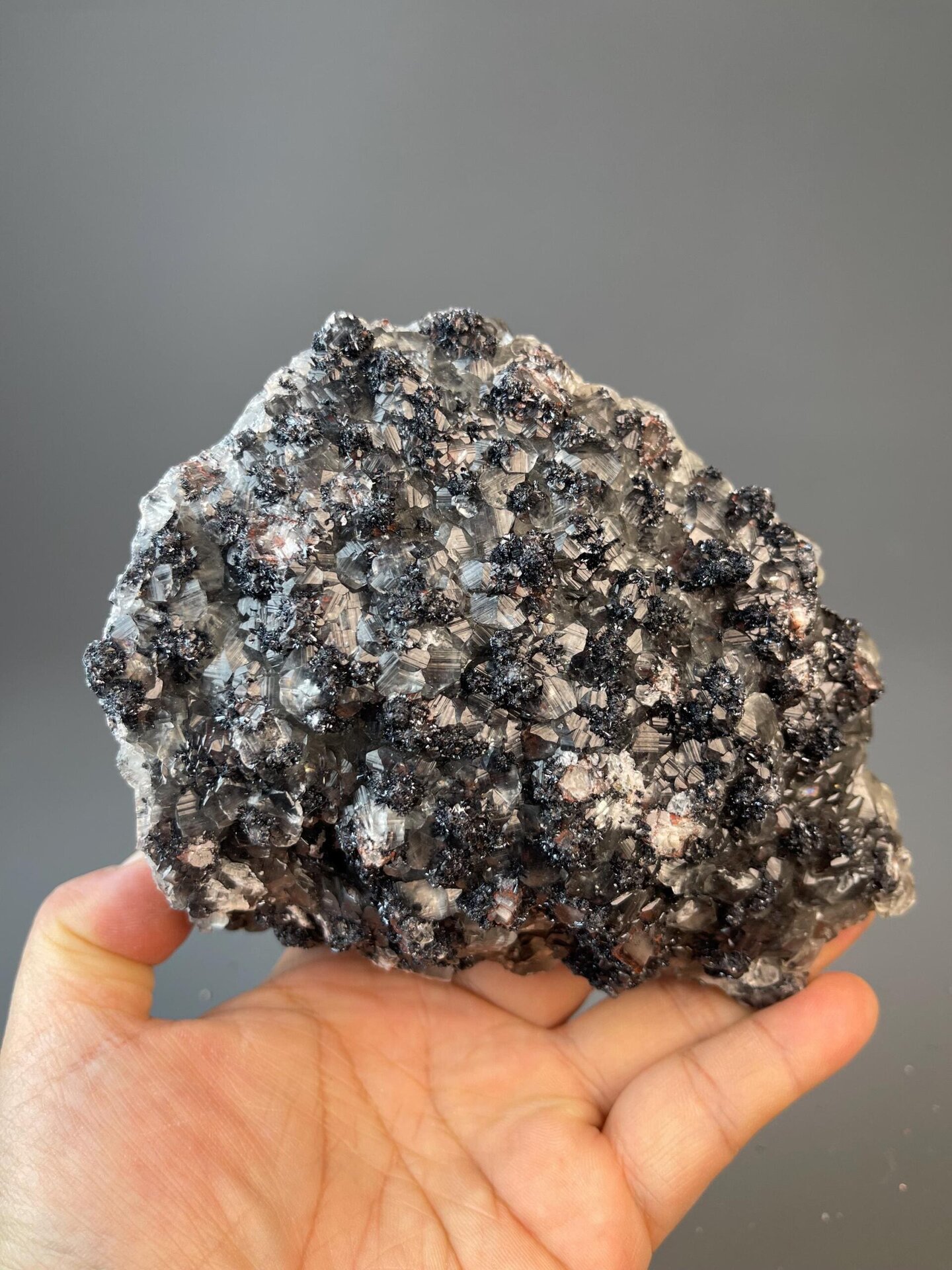 Complex hematite and calcite mineral association specimen