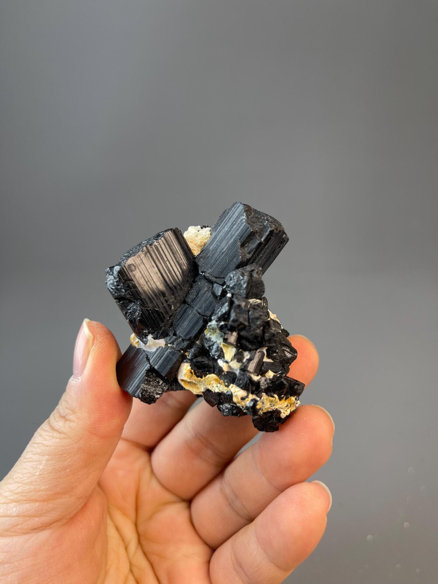 Black tourmaline with glossy X-shaped crossing crystal habit