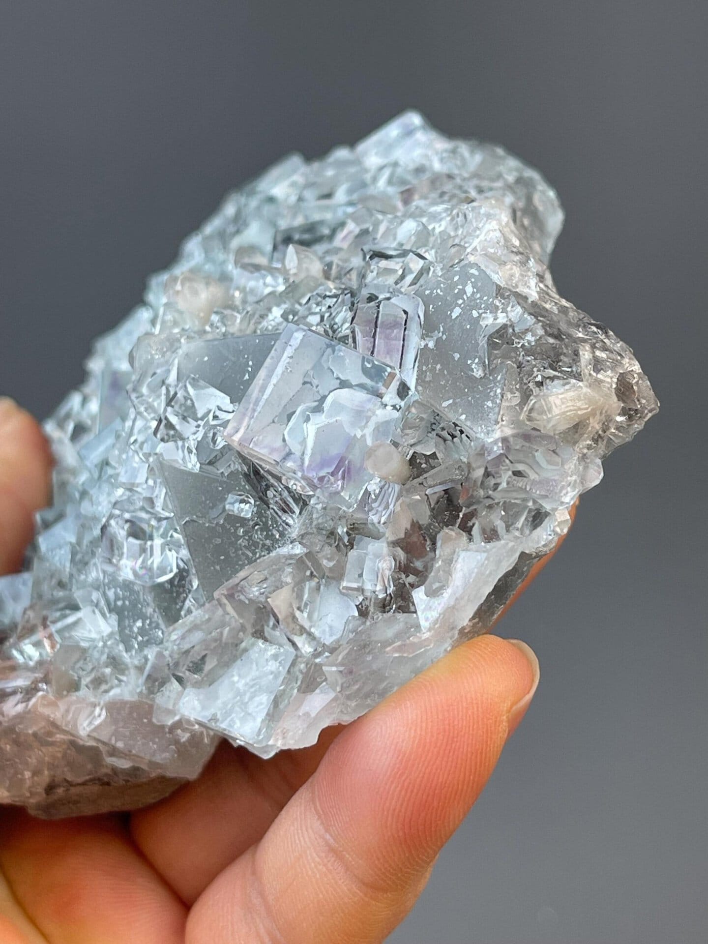 Clear fluorite cubic crystals appearing to float on matrix