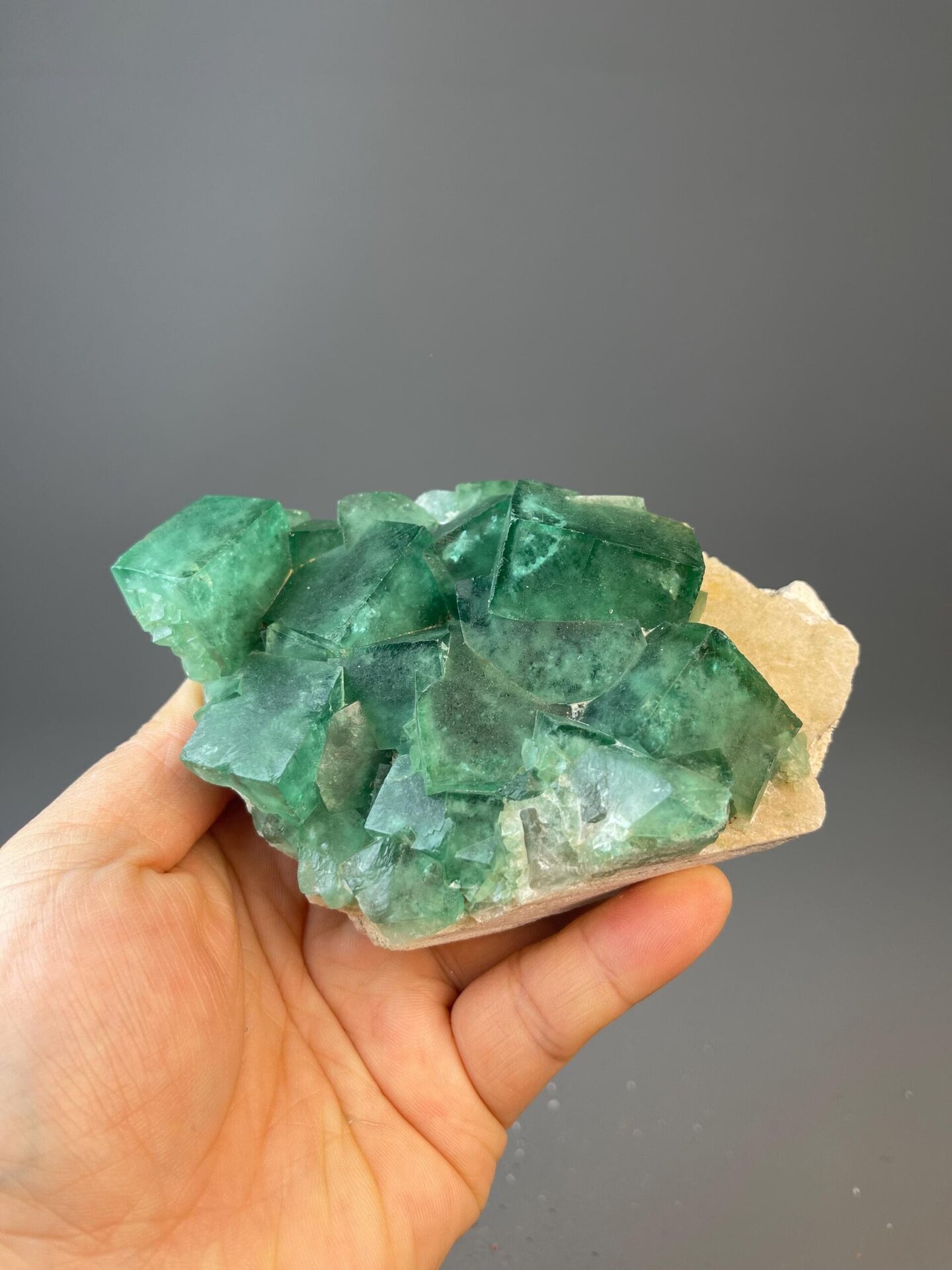 Vivid green fluorite crystals on golden matrix from Madagascar