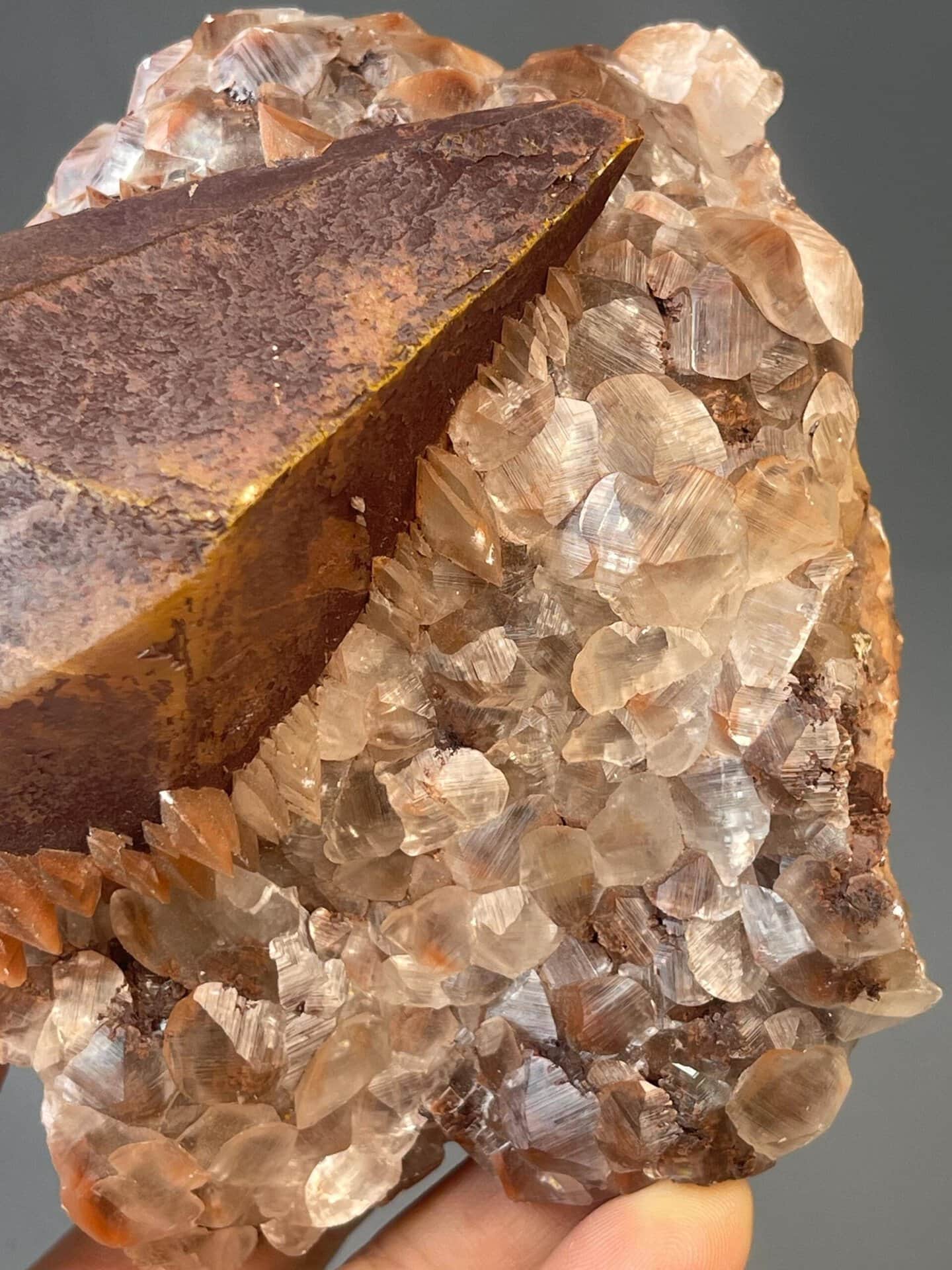 Large red calcite with iron staining and octahedral form