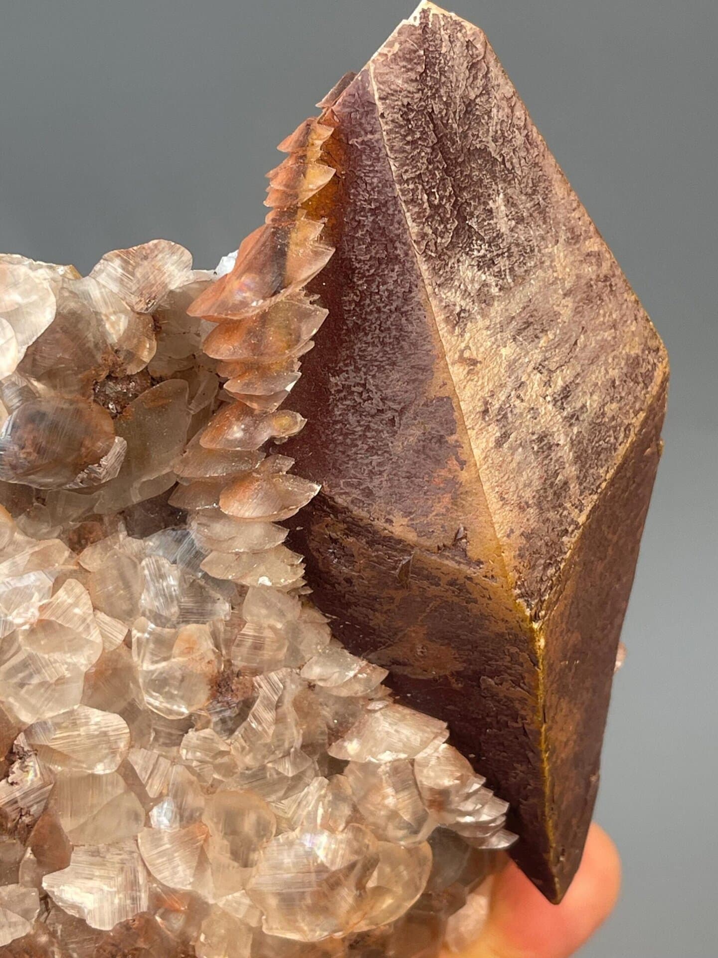 Red octahedral calcite crystal with scalenohedral faces