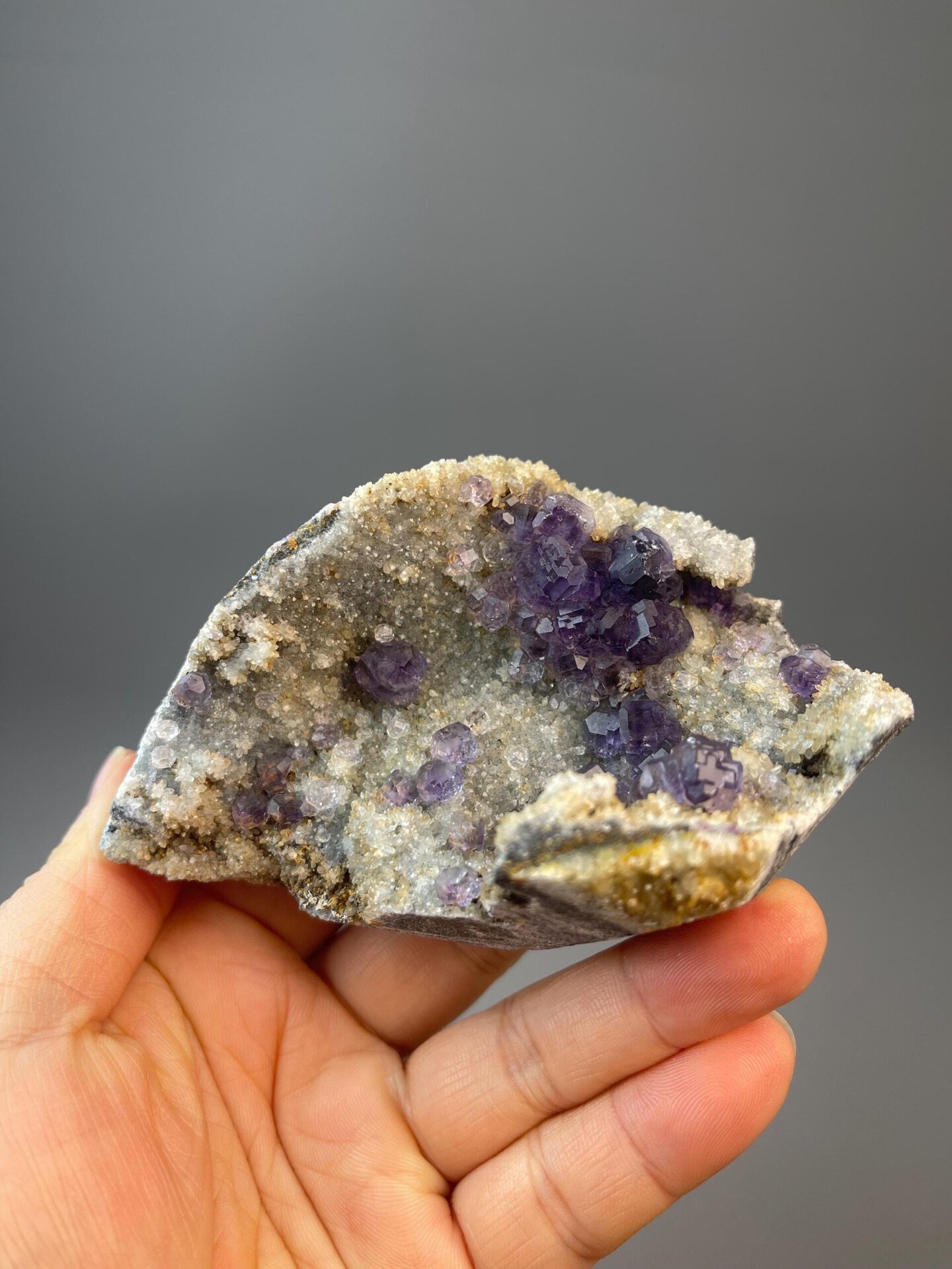 Deep purple tanzan fluorite spheres on white quartz base