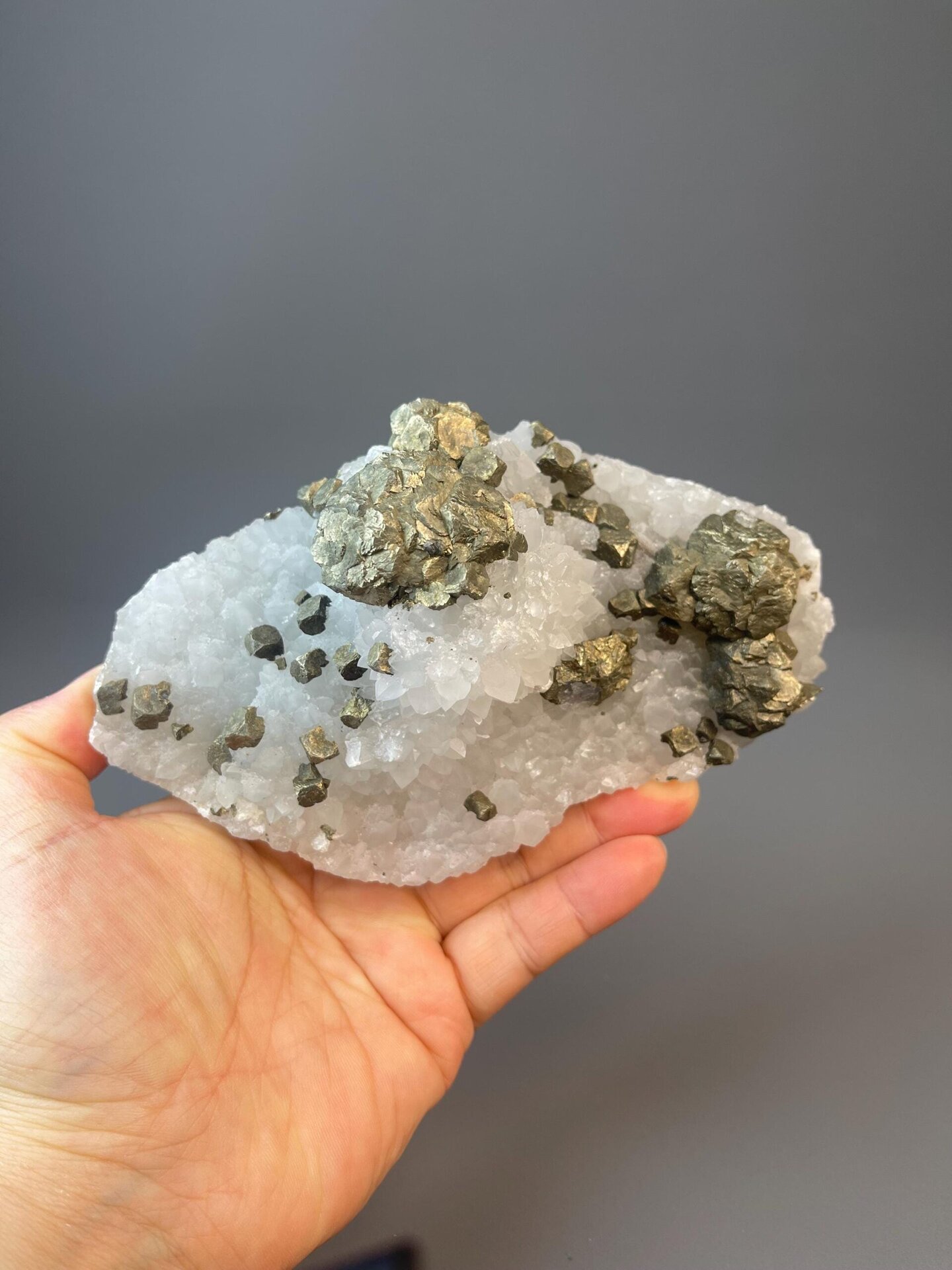 Iridescent chalcopyrite sphere with brassy metallic surface