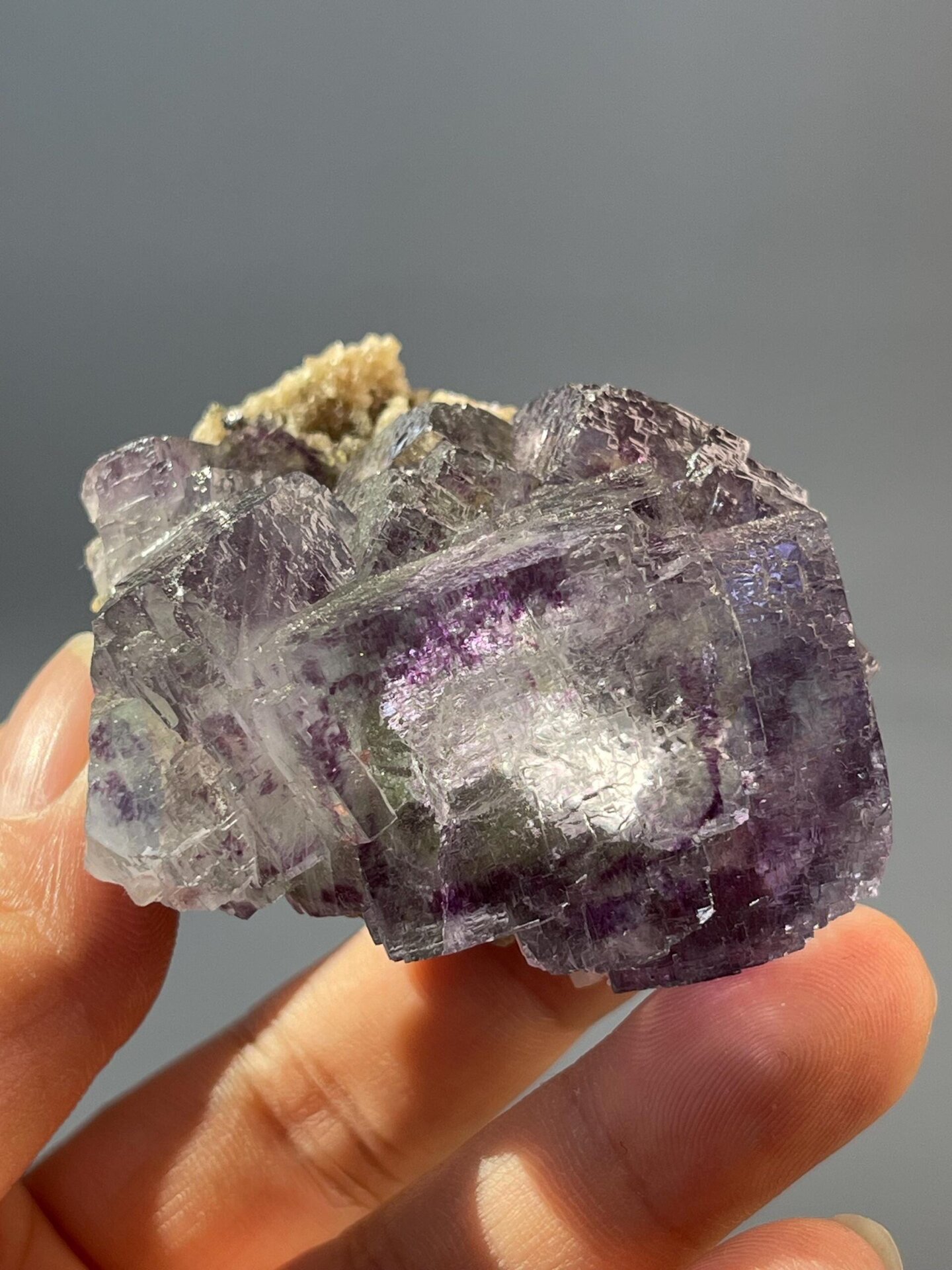 Large transparent window in stepped fluorite crystal