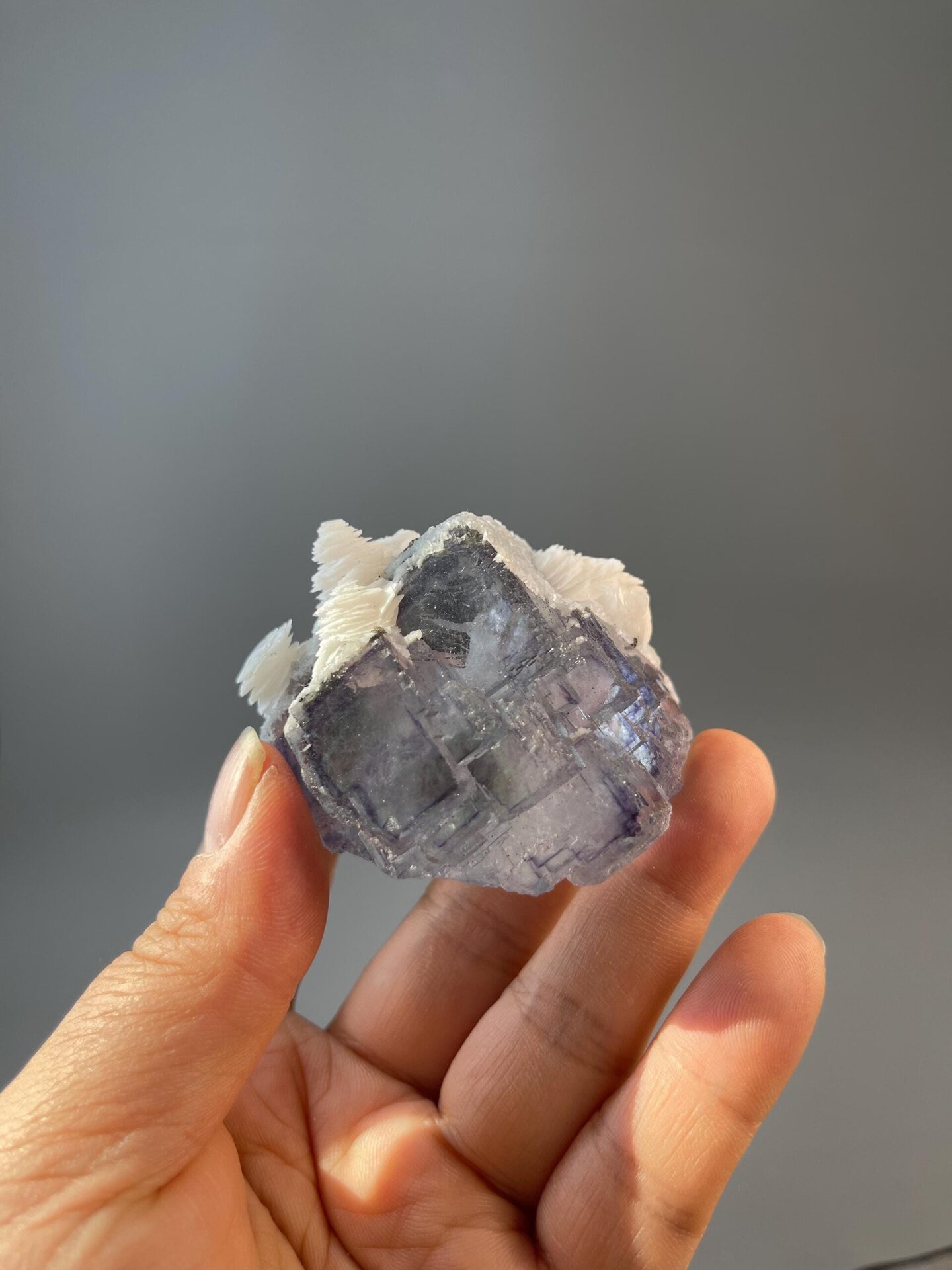 Close-up of white calcite petal formations on fluorite