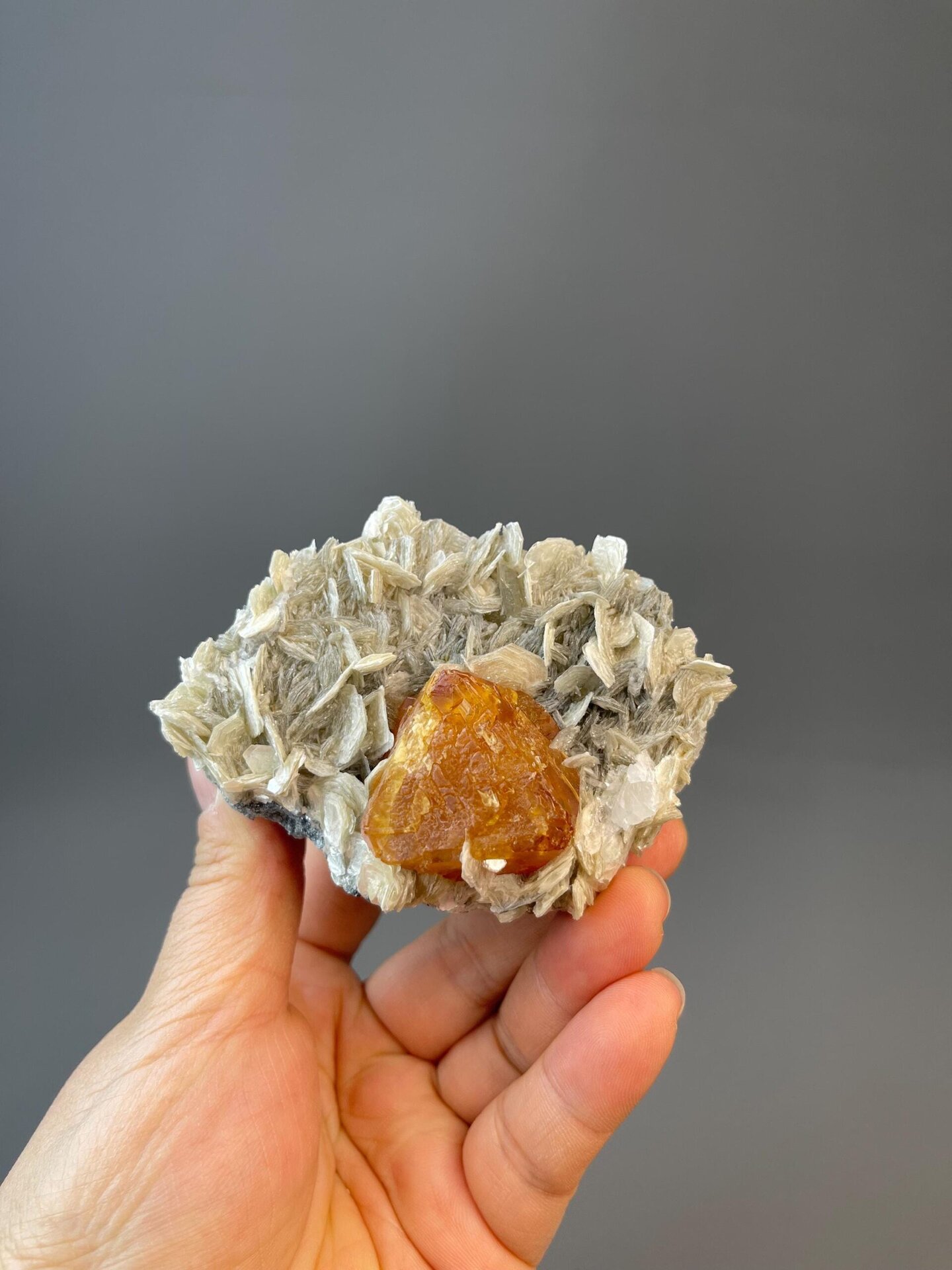 Close-up of scheelite octahedron faces showing orange color