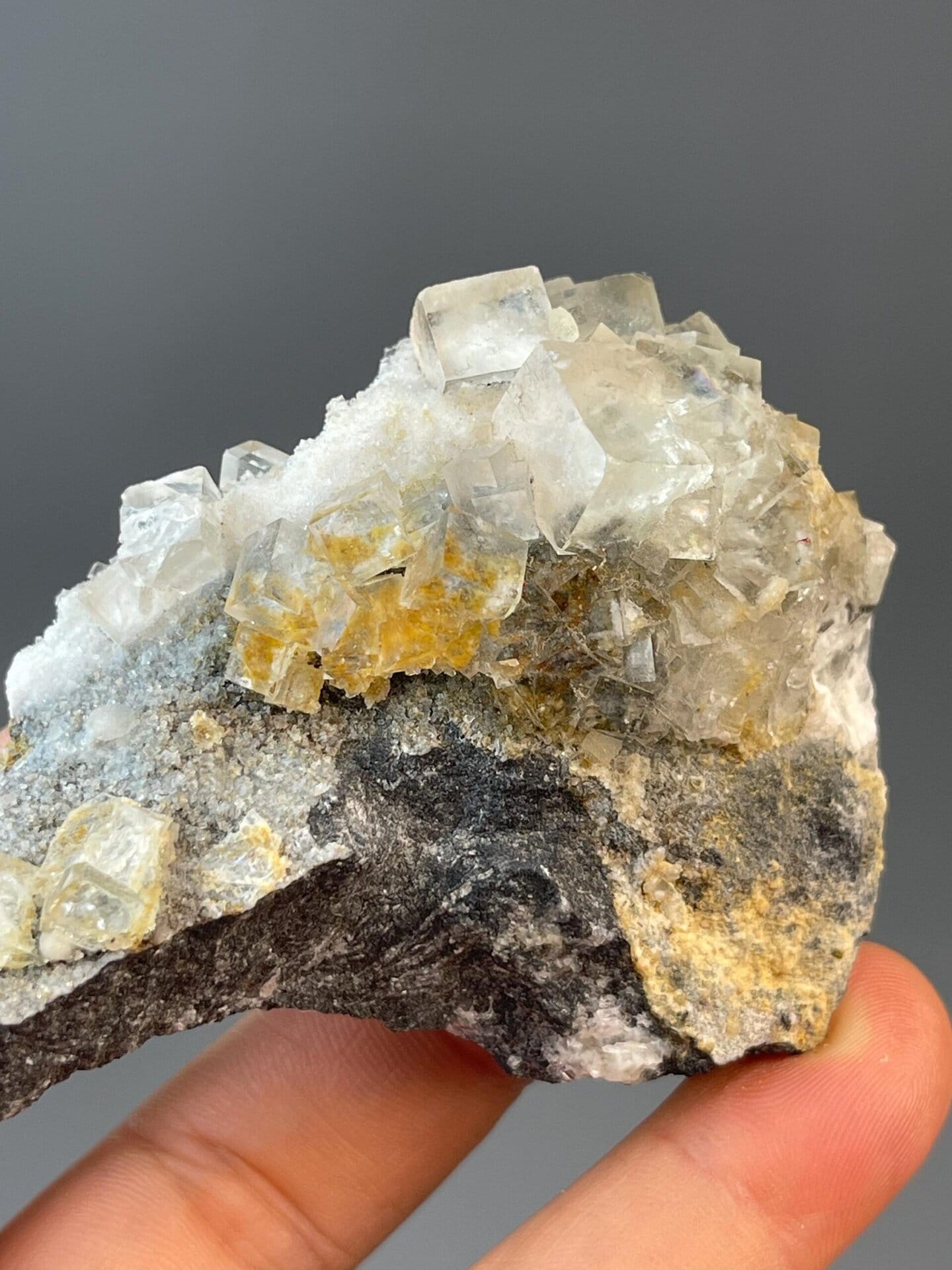 Side view of fluorite cube on rock matrix