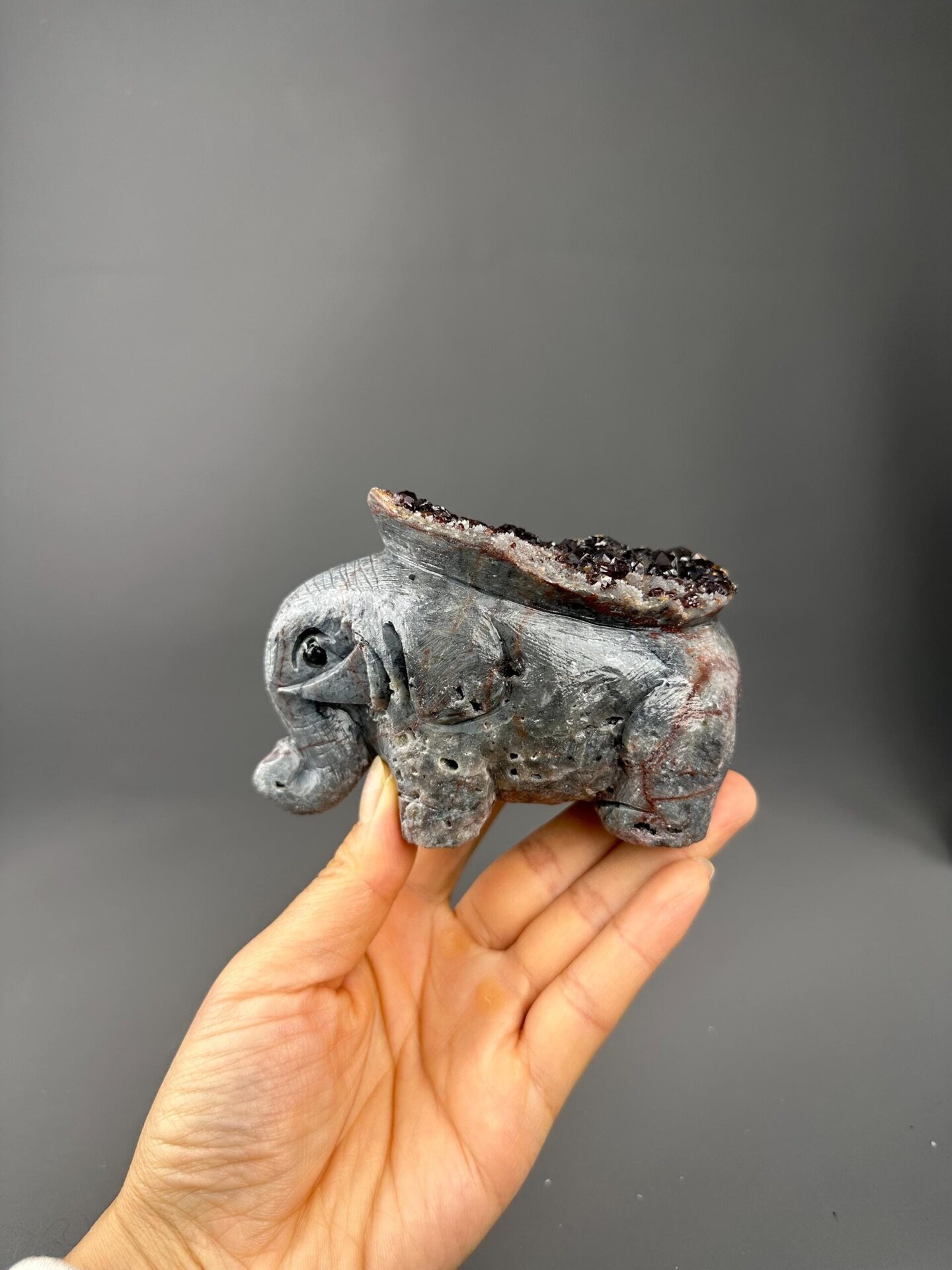 Side profile of garnet elephant carving