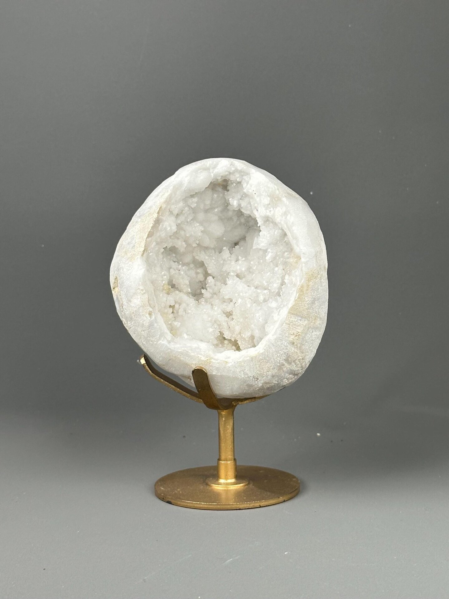 Large quartz geode on decorative gold metal base