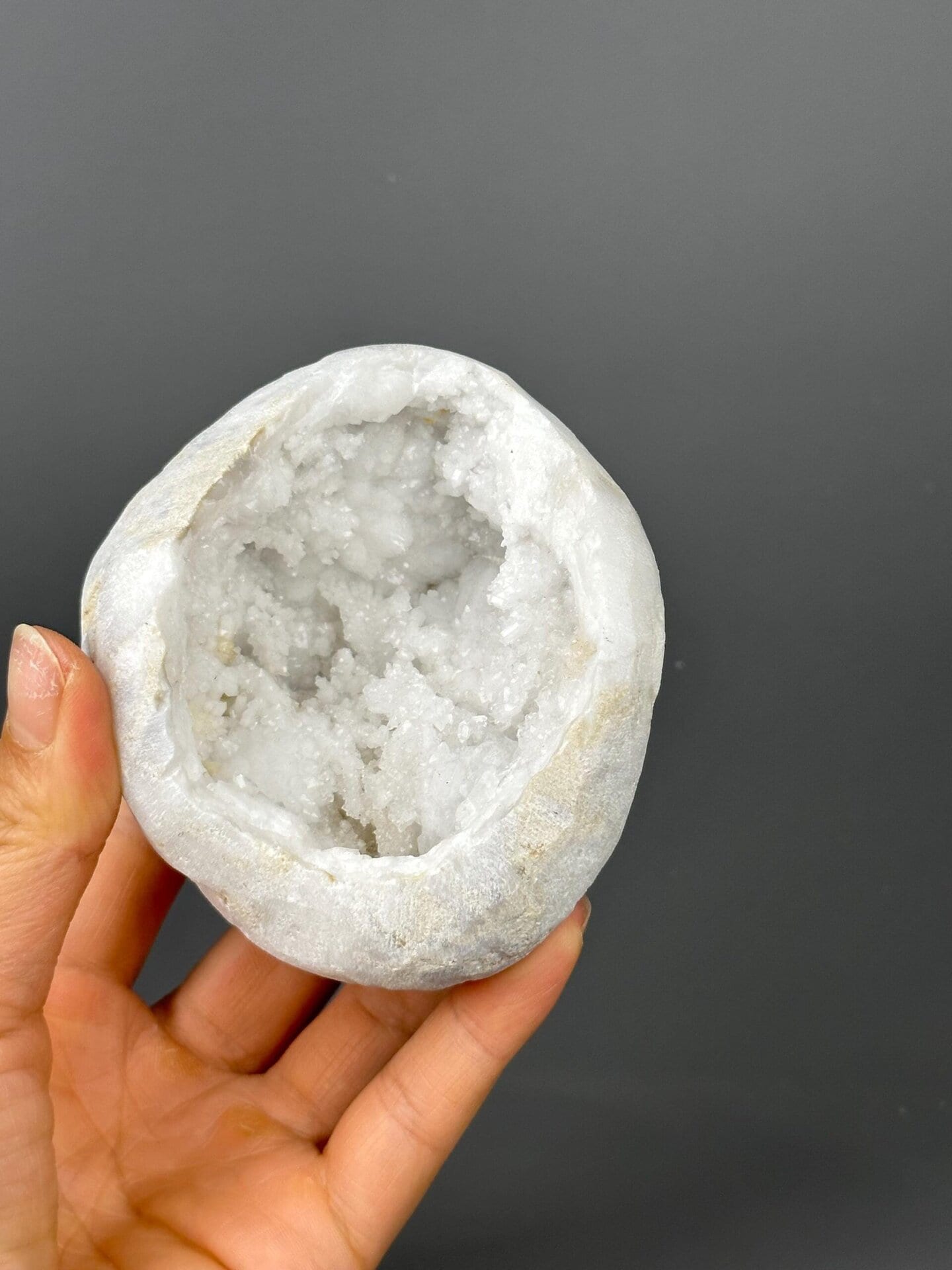 Top opening of large quartz geode on gold base