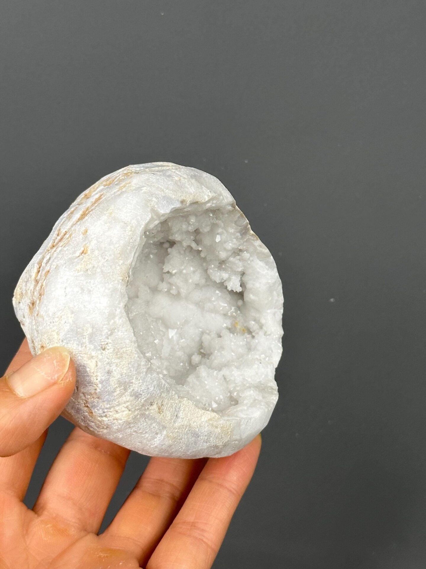 Large quartz geode on gold base with scale reference