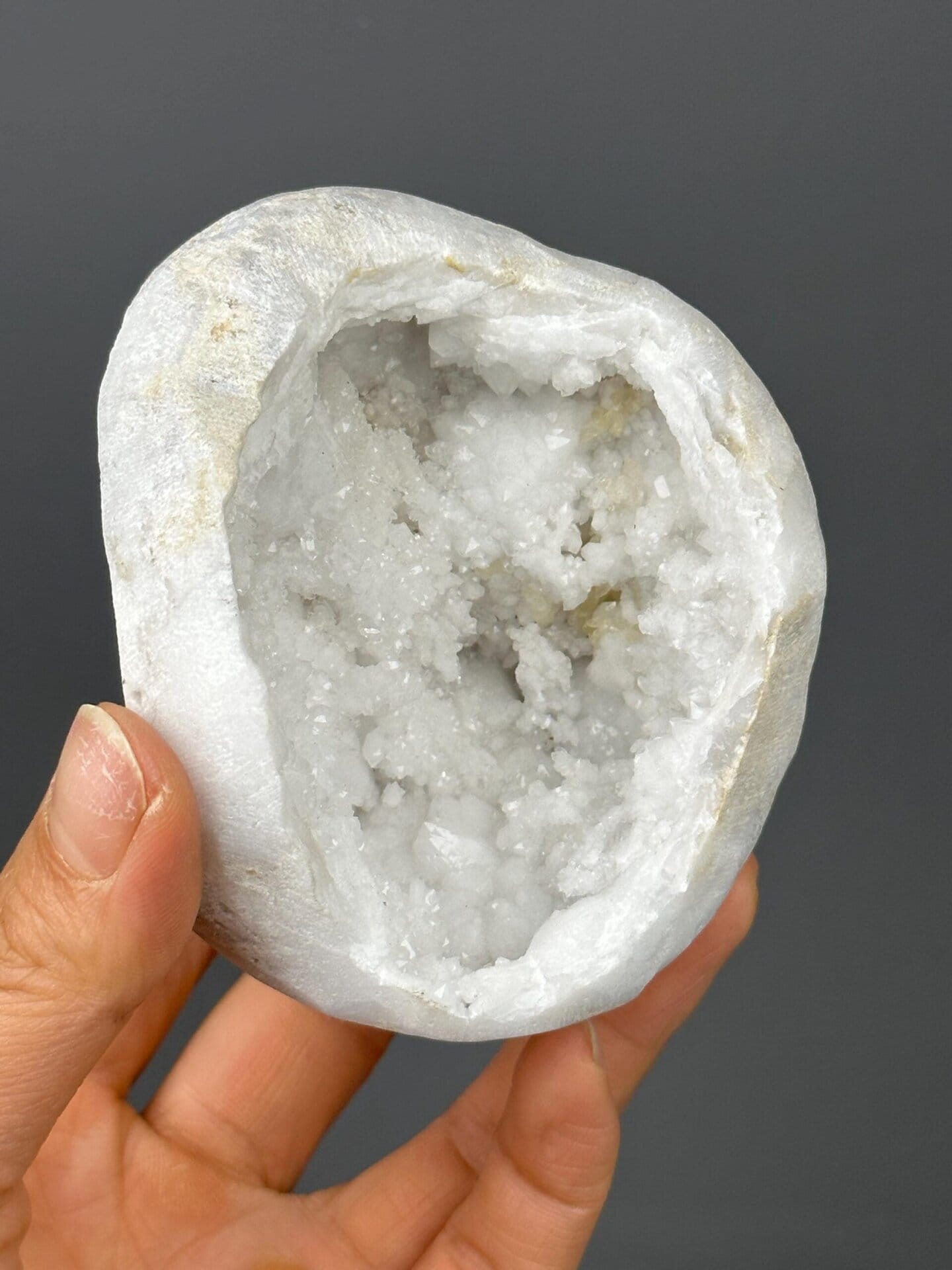 Gold base support beneath large quartz geode