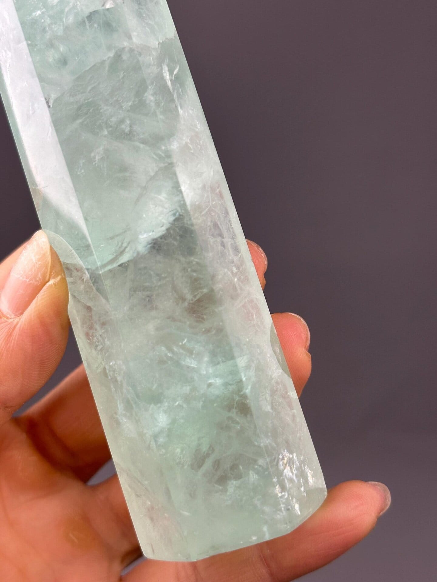 Angled view of polished green fluorite tower