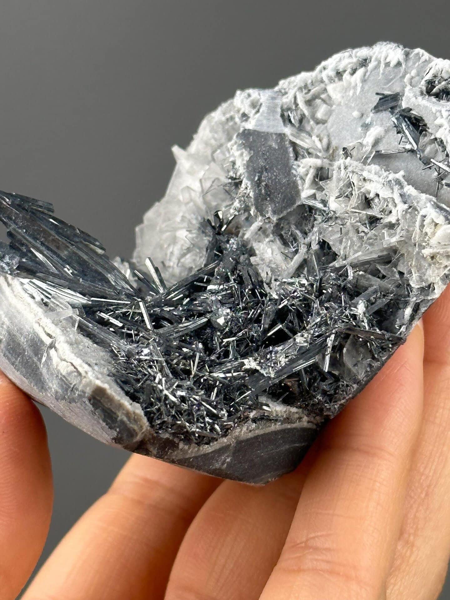 Stibnite barite cluster on white background