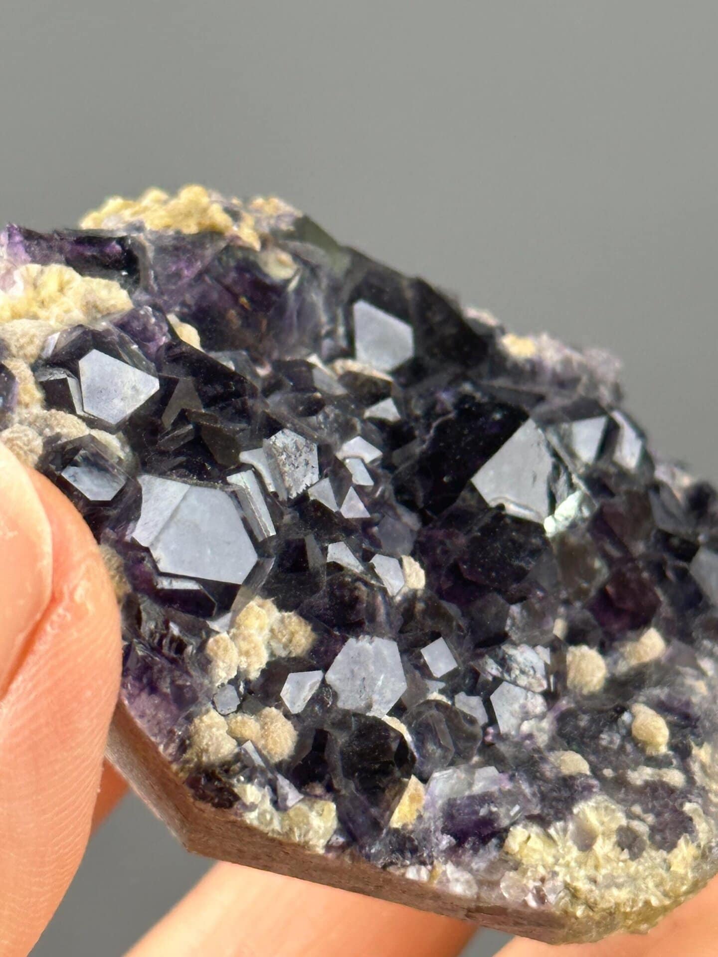 Full deep purple fluorite specimen on white background